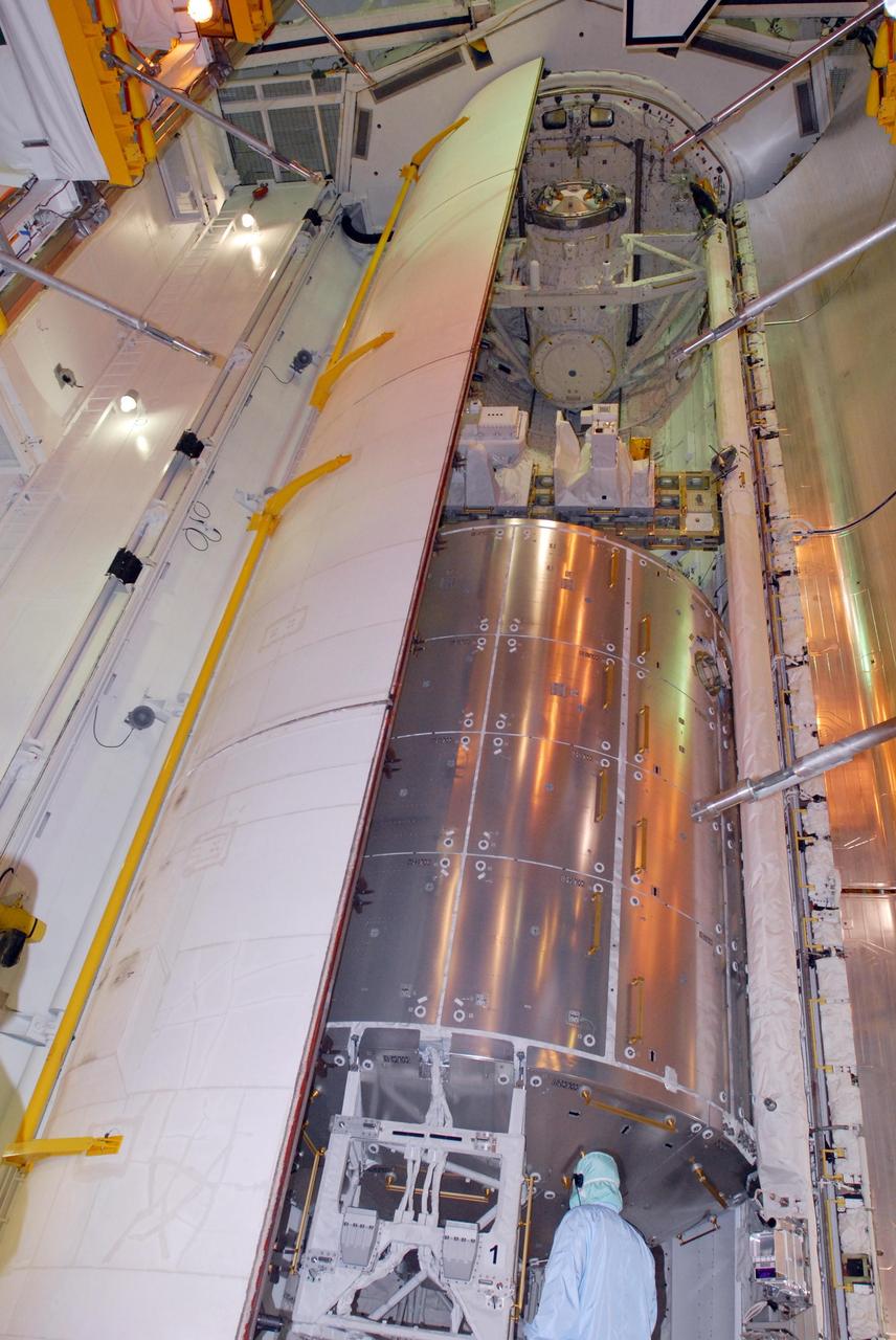 KENNEDY SPACE CENTER, FLA. -- On Launch Pad 39A, space shuttle Atlantis' payload bay doors are closing. Seen here are the Columbus Laboratory (below), the integrated cargo carrier - lite (middle) and the orbital docking system (above). Atlantis is being secured for launch on Dec. 6 on mission STS-122 to the International Space Station. The Columbus laboratory module, built by the European Space Agency, is approximately 23 feet long and 15 feet wide, allowing it to hold 10 large racks of experiments. The carrier holds three elements: a nitrogen tank assembly that is part of the external active thermal control system on the International Space Station, the European Technology Exposure Facility composed of nine science instruments and an autonomous temperature measurement unit, and the SOLAR payload designed for sun observation. Photo credit: NASA/George Shelton
