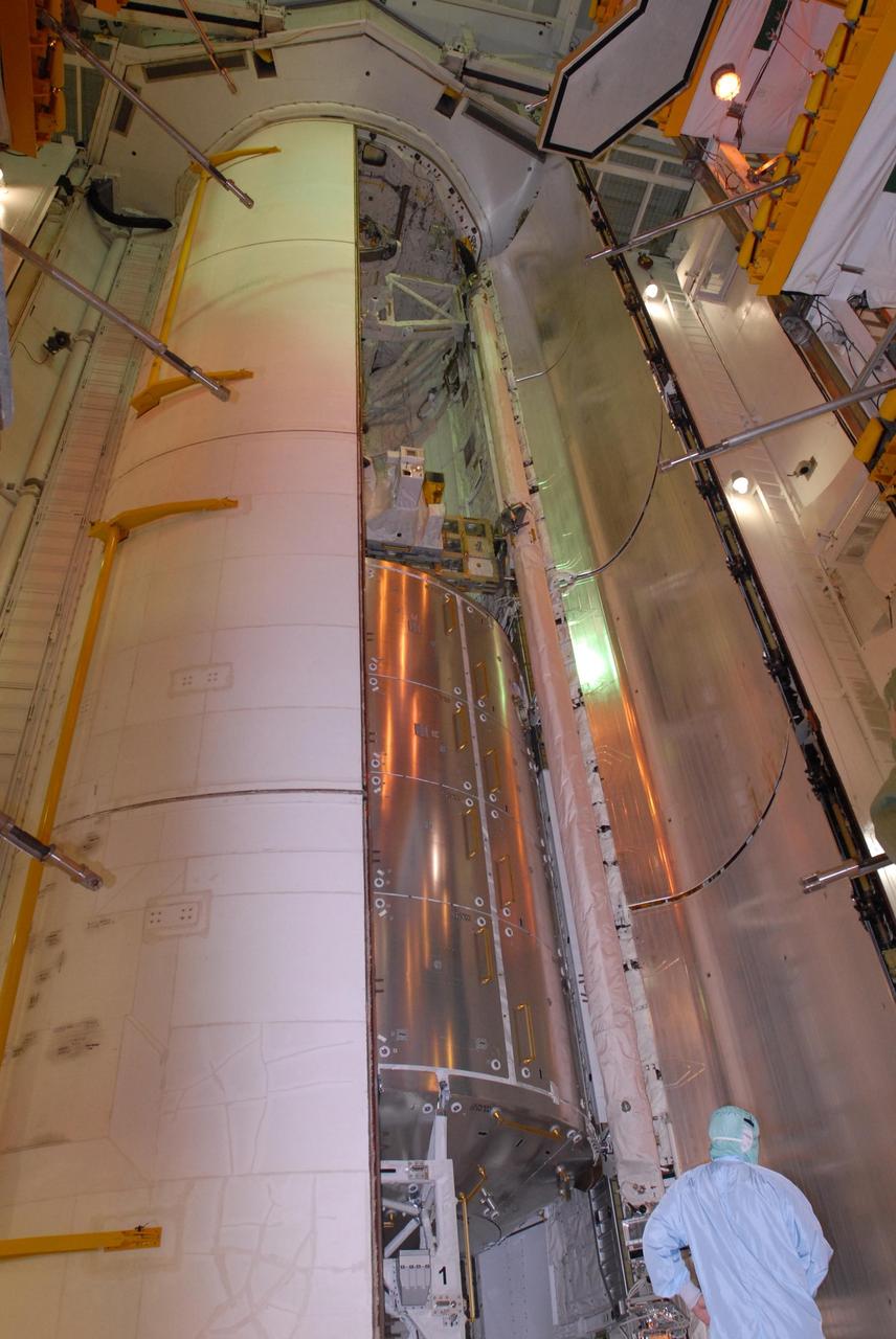 KENNEDY SPACE CENTER, FLA. -- On Launch Pad 39A, one of space shuttle Atlantis' payload bay doors is nearly closed. Inside can still be seen the Columbus Laboratory (below), the integrated cargo carrier - lite (middle) and the orbital docking system (above). Atlantis is being secured for launch on Dec. 6 on mission STS-122 to the International Space Station. The Columbus laboratory module, built by the European Space Agency, is approximately 23 feet long and 15 feet wide, allowing it to hold 10 large racks of experiments. The carrier holds three elements: a nitrogen tank assembly that is part of the external active thermal control system on the International Space Station, the European Technology Exposure Facility composed of nine science instruments and an autonomous temperature measurement unit, and the SOLAR payload designed for sun observation. Photo credit: NASA/George Shelton