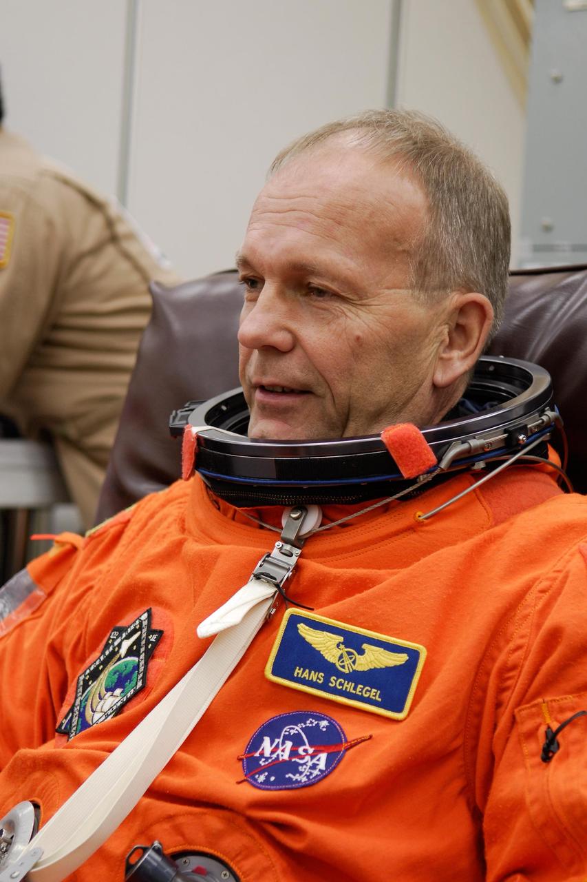 KENNEDY SPACE CENTER, FLA. -- STS-122 Mission Specialist Hans Schlegel dons his launch and entry suit for a final fitting before space shuttle Atlantis' launch scheduled for 4:31 p.m. EST on Dec. 6. Schlegel, who represents the European Space Agency, will make his second shuttle flight. Atlantis will carry the Columbus Lab, Europe’s largest contribution to the construction of the International Space Station. It will support scientific and technological research in a microgravity environment. Columbus, a program of ESA, is a multifunctional, pressurized laboratory that will be permanently attached to Node 2 of the space station to carry out experiments in materials science, fluid physics and biosciences, as well as to perform a number of technological applications. Photo credit: NASA/Kim Shiflett