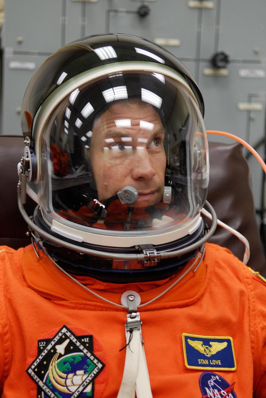 KENNEDY SPACE CENTER, FLA. --   STS-122 Mission Specialist Stanley Love checks the fit of his helmet for his launch and entry suit before space shuttle Atlantis' launch scheduled for 4:31 p.m. EST on Dec. 6.  Love will make his first shuttle flight. Atlantis will carry the Columbus Lab, Europe’s largest contribution to the construction of the International Space Station. It will support scientific and technological research in a microgravity environment. Columbus, a program of ESA, is a multifunctional, pressurized laboratory that will be permanently attached to Node 2 of the space station to carry out experiments in materials science, fluid physics and biosciences, as well as to perform a number of technological applications.   Photo credit: NASA/Kim Shiflett