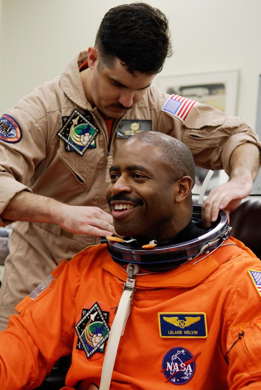 KENNEDY SPACE CENTER, FLA. --  STS-122 Mission Specialist Leland Melvin dons his launch and entry suit for a final fitting before space shuttle Atlantis' launch scheduled for 4:31 p.m. EST on Dec. 6.  Melvin will make his first shuttle flight.  Atlantis will carry the Columbus Lab, Europe’s largest contribution to the construction of the International Space Station. It will support scientific and technological research in a microgravity environment. Columbus, a program of ESA, is a multifunctional, pressurized laboratory that will be permanently attached to Node 2 of the space station to carry out experiments in materials science, fluid physics and biosciences, as well as to perform a number of technological applications.   Photo credit: NASA/Kim Shiflett