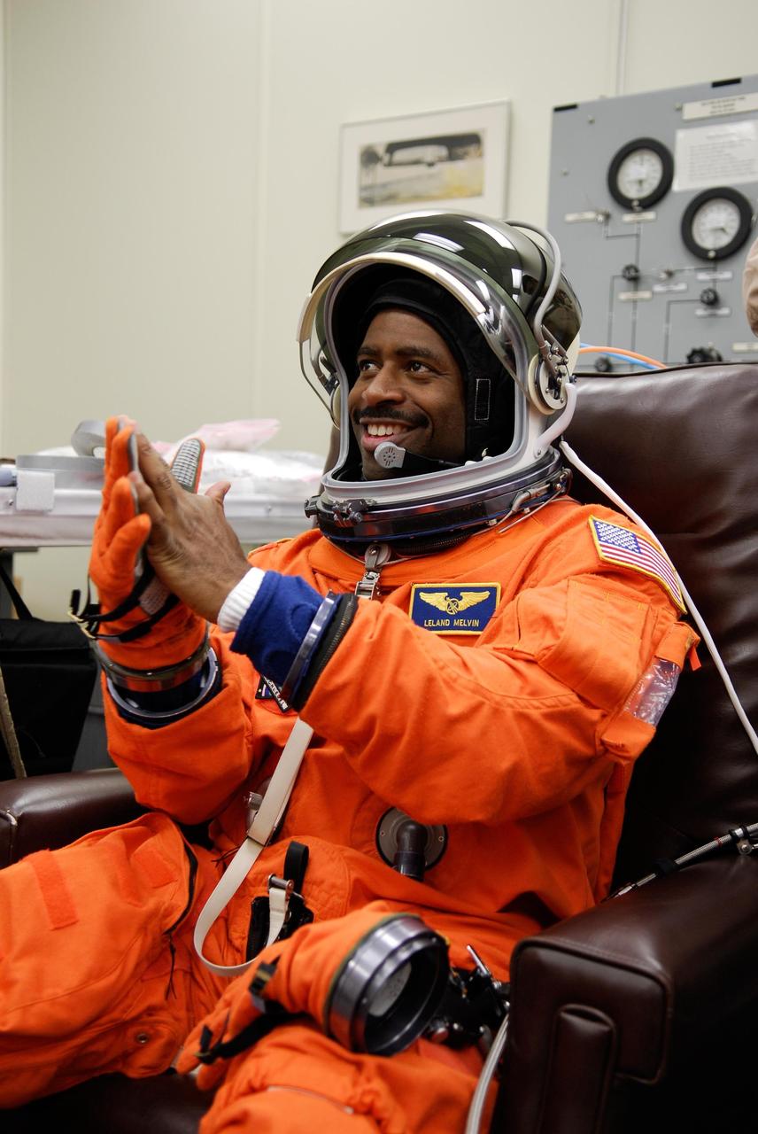 KENNEDY SPACE CENTER, FLA. --  STS-122 Mission Specialist Leland Melvin tests his gloves for a final fitting before space shuttle Atlantis' launch scheduled for 4:31 p.m. EST on Dec. 6.  Melvin will make his first shuttle flight.  Atlantis will carry the Columbus Lab, Europe’s largest contribution to the construction of the International Space Station. It will support scientific and technological research in a microgravity environment. Columbus, a program of ESA, is a multifunctional, pressurized laboratory that will be permanently attached to Node 2 of the space station to carry out experiments in materials science, fluid physics and biosciences, as well as to perform a number of technological applications.   Photo credit: NASA/Kim Shiflett
