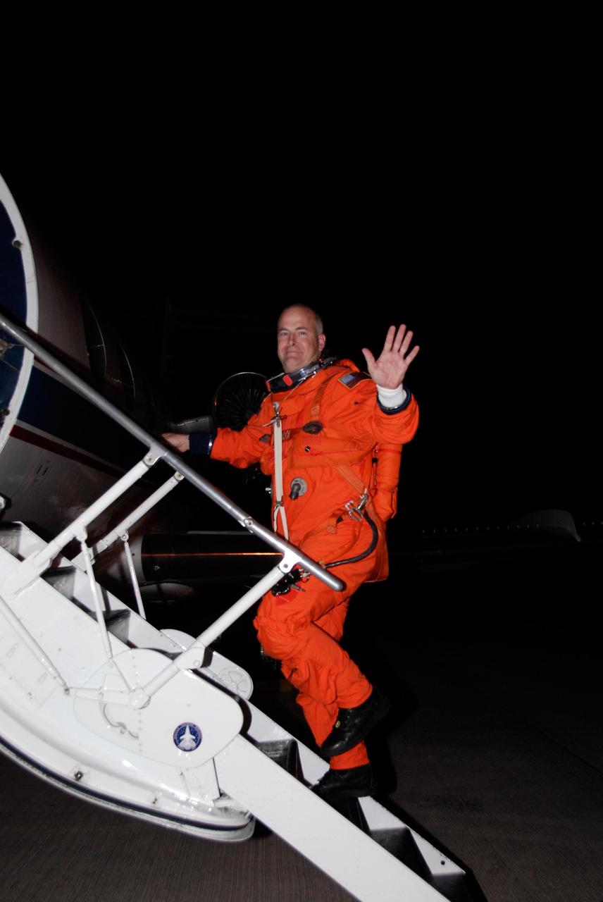 KENNEDY SPACE CENTER, FLA. --   Dressed in his launch and entry suit, STS-122 Pilot Alan Poindexter climbs the steps to the shuttle training aircraft, or STA, at NASA's Kennedy Space Center.  Poindexter and Commander Steve Frick will practice shuttle landings in the STA before the Dec. 6 launch on space shuttle Atlantis.  The STA is a Grumman American Aviation-built Gulf Stream II jet that was modified to simulate an orbiter's cockpit, motion and visual cues, and handling qualities.  Photo credit: NASA/Kim Shiflett