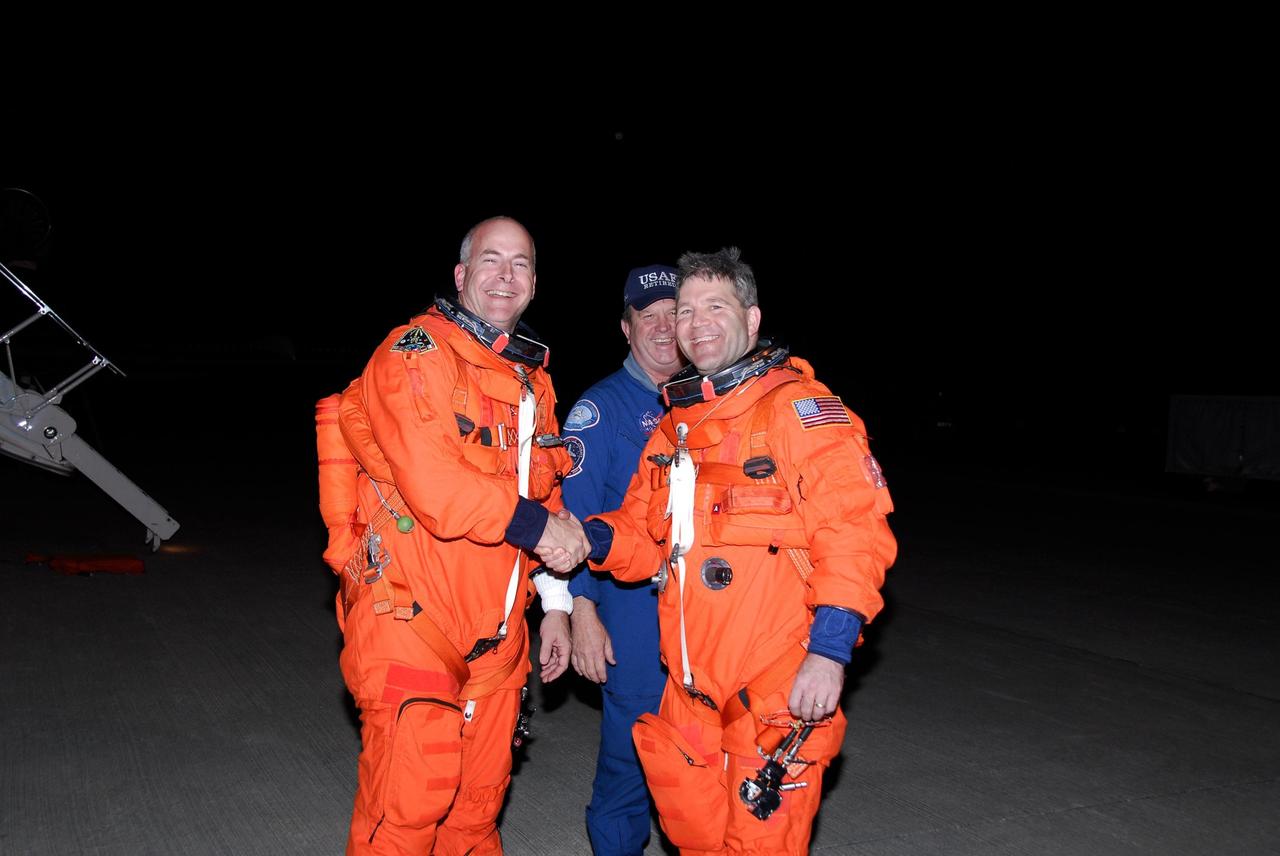 KENNEDY SPACE CENTER, FLA. --  STS-122 Commander Steve Frick (right) and Pilot Alan Poindexter (left) congratulate each other on the successful landing practice completed aboard a shuttle training aircraft, or STA, at Kennedy Space Center's Shuttle Landing Facility.  They are preparing for the Dec. 6 launch on space shuttle Atlantis.  The STA is a Grumman American Aviation-built Gulf Stream II jet that was modified to simulate an orbiter's cockpit, motion and visual cues, and handling qualities.  Photo credit: NASA/Kim Shiflett