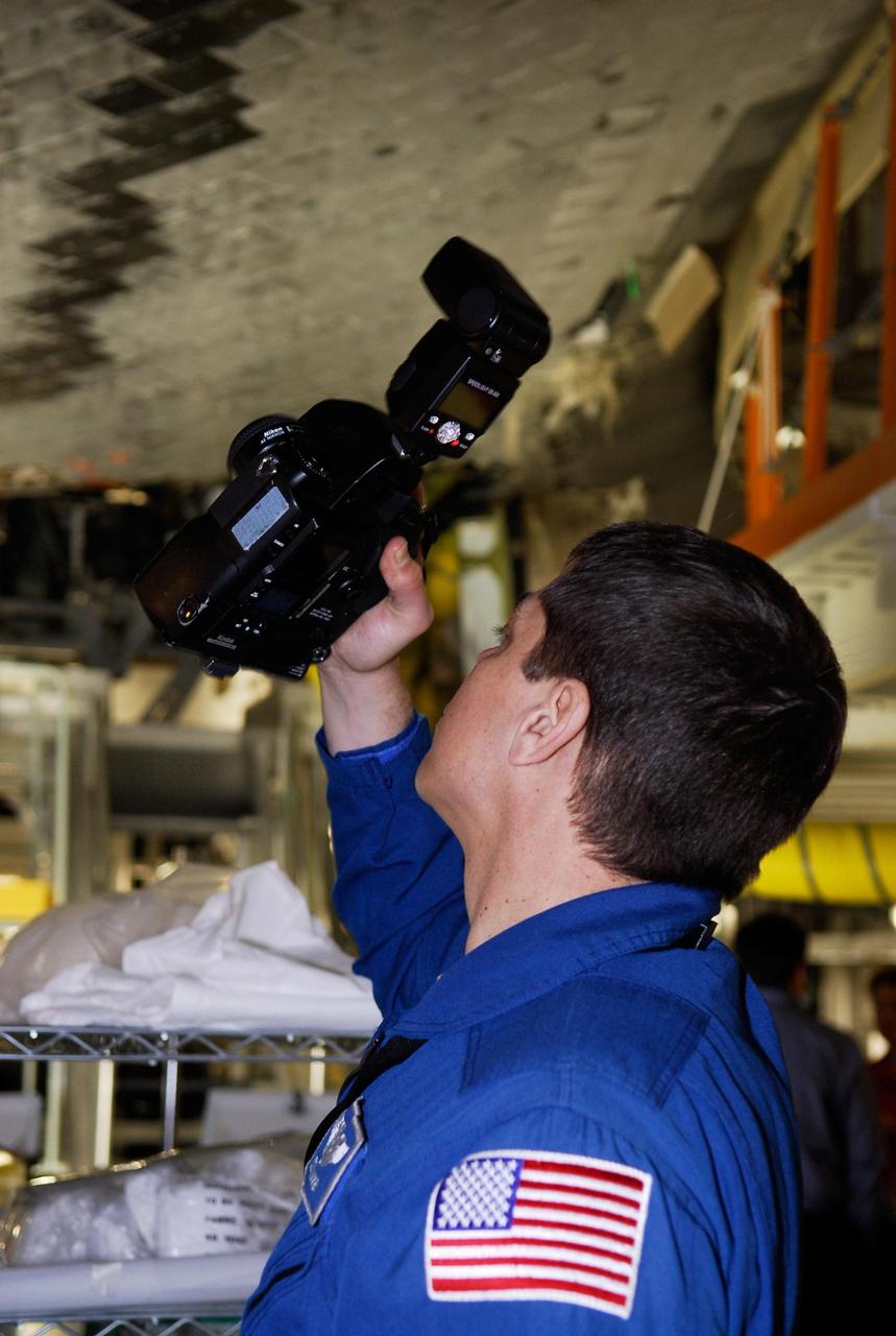 KENNEDY SPACE CENTER, FLA. -- In the Orbiter Processing Facility, STS-123 Mission Specialist Takao Doi tries out one of the cameras that will be used on the mission. Doi represents the Japanese Aerospace and Exploration Agency. He and other crew members are at NASA's Kennedy Space Center for a crew equipment interface test, a process of familiarization with payloads, hardware and the space shuttle. The STS-123 mission is targeted for launch on space shuttle Endeavour on Feb. 14. It will be the 25th assembly flight of the station. Photo credit: NASA/Kim Shiflett