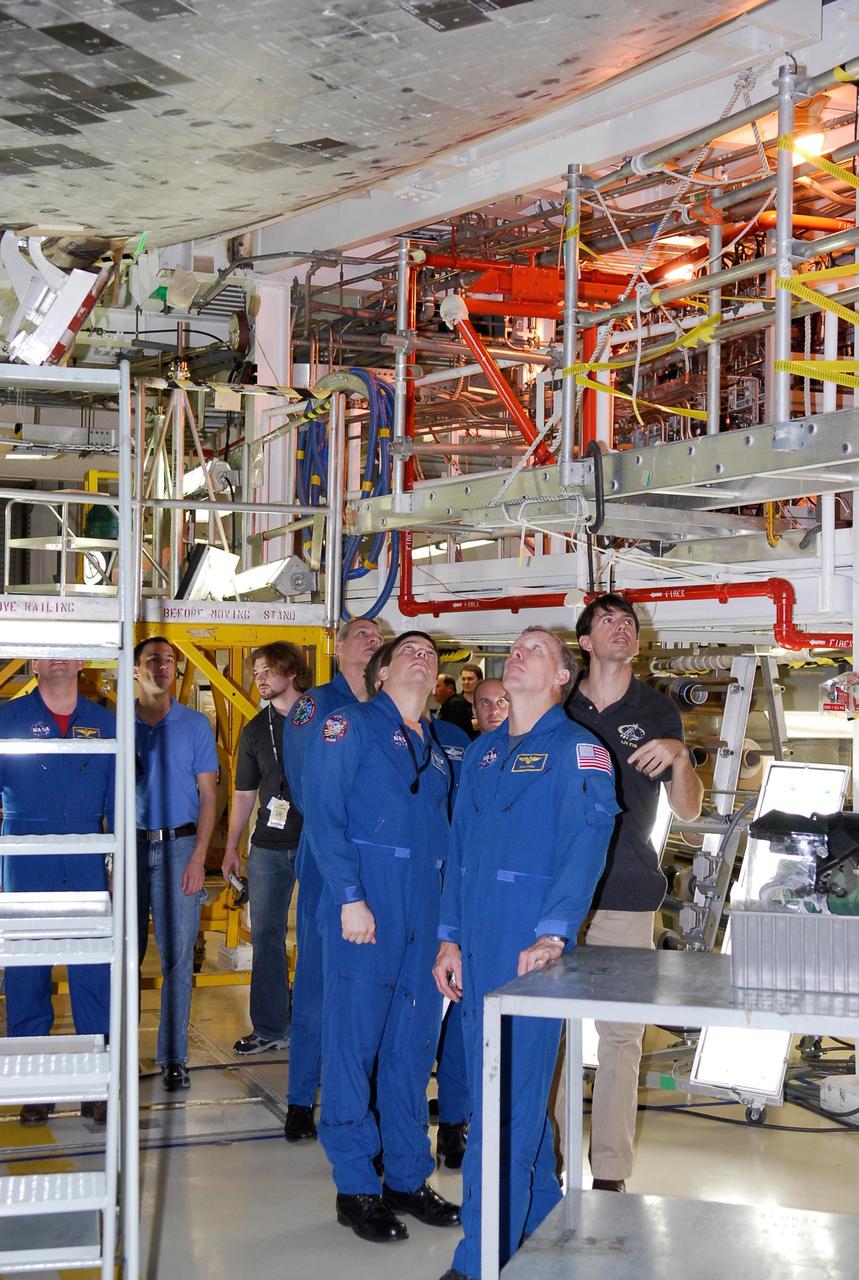 KENNEDY SPACE CENTER, FLA. --   In the Orbiter Processing Facility, STS-123 crew members inspect the thermal protection system tiles on the underside of space shuttle Endeavour.  In the center are Mission Specialists Richard Linnehan and Robert Behnken, and Commander Dominic Gorie.  They are at NASA's Kennedy Space Center for a crew equipment interface test, a process of familiarization with payloads, hardware and the space shuttle. The STS-123 mission is targeted for launch on space shuttle Endeavour on Feb. 14.  It will be the 25th assembly flight of the station.   Photo credit: NASA/Kim Shiflett