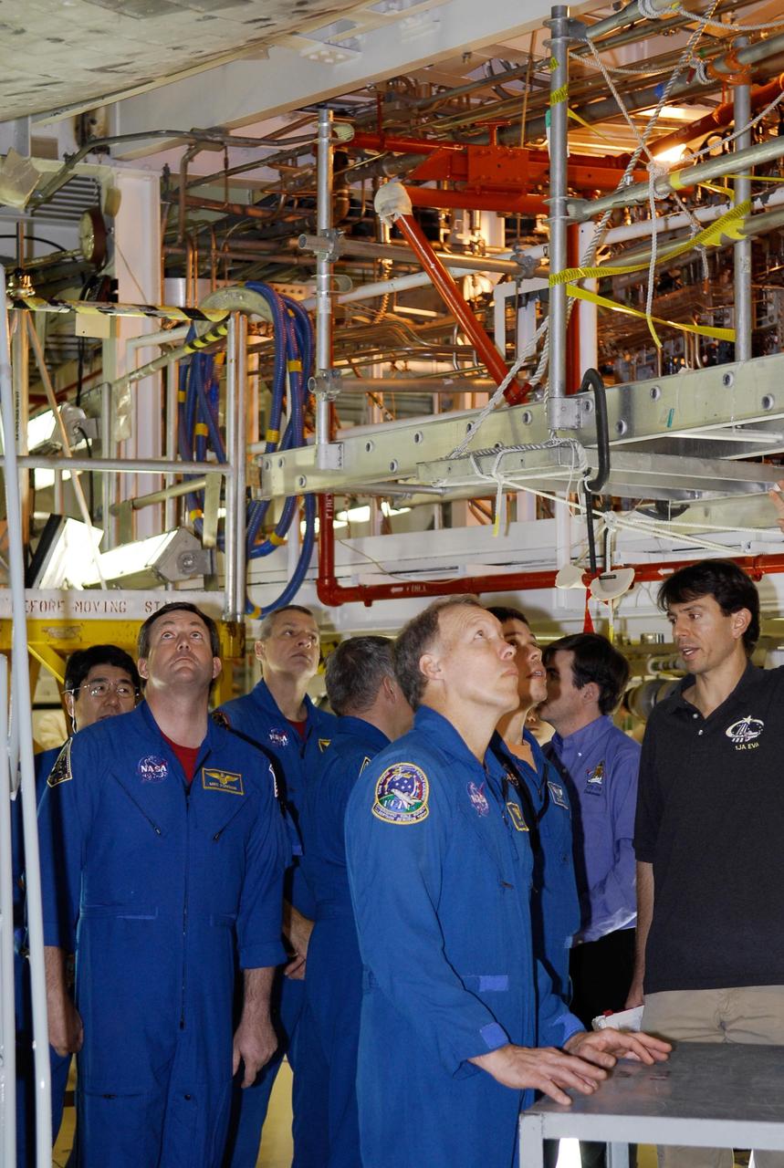 KENNEDY SPACE CENTER, FLA. --  In the Orbiter Processing Facility, STS-123 crew members inspect the thermal protection system tiles on the underside of space shuttle Endeavour. From left are Mission Specialists Takao Doi, Michael Foreman and Richard Linnehan, Pilot Gregory Johnson (turned away), Commander Dominic Gorie and Mission Specialist Robert Behnken.  They are at NASA's Kennedy Space Center for a crew equipment interface test, a process of familiarization with payloads, hardware and the space shuttle. The STS-123 mission is targeted for launch on space shuttle Endeavour on Feb. 14.  It will be the 25th assembly flight of the station.   Photo credit: NASA/Kim Shiflett