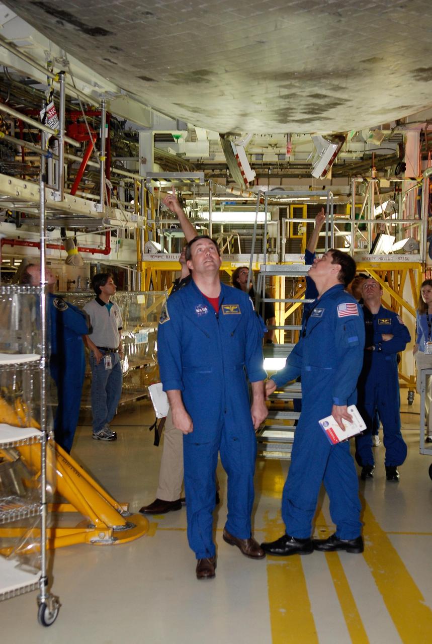 KENNEDY SPACE CENTER, FLA. -- In the Orbiter Processing Facility, STS-123 Mission Specialists Michael Foreman and Robert Behnken inspect the thermal protection system tiles on the underside of space shuttle Endeavour. They and other crew members are at NASA's Kennedy Space Center for a crew equipment interface test, a process of familiarization with payloads, hardware and the space shuttle. The STS-123 mission is targeted for launch on space shuttle Endeavour on Feb. 14. It will be the 25th assembly flight of the station. Photo credit: NASA/Kim Shiflett