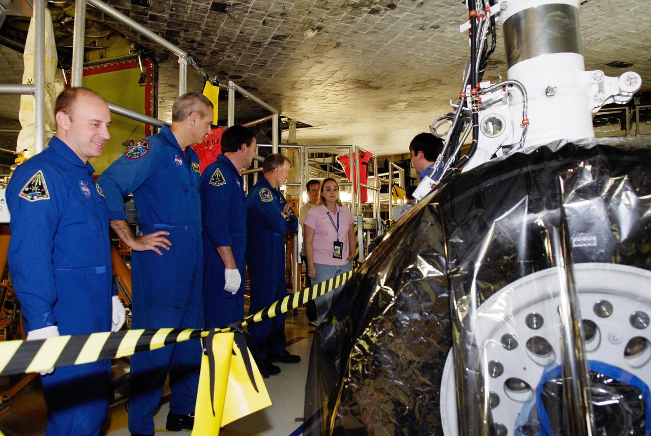 KENNEDY SPACE CENTER, FLA. --  In the Orbiter Processing Facility, STS-123 crew members check out the underside of space shuttle Endeavour.  From left are Mission Specialists Garrett Reisman, Richard Linnehan and Robert Behnken, and Commander Dominic Gorie. They and other crew members are at NASA's Kennedy Space Center for a crew equipment interface test, a process of familiarization with payloads, hardware and the space shuttle.  Reisman will join the Expedition 16 crew on the International Space Station, replacing flight engineer Leopold Eyharts. The STS-123 mission is targeted for launch on space shuttle Endeavour on Feb. 14.  It will be the 25th assembly flight of the station.   Photo credit: NASA/Kim Shiflett