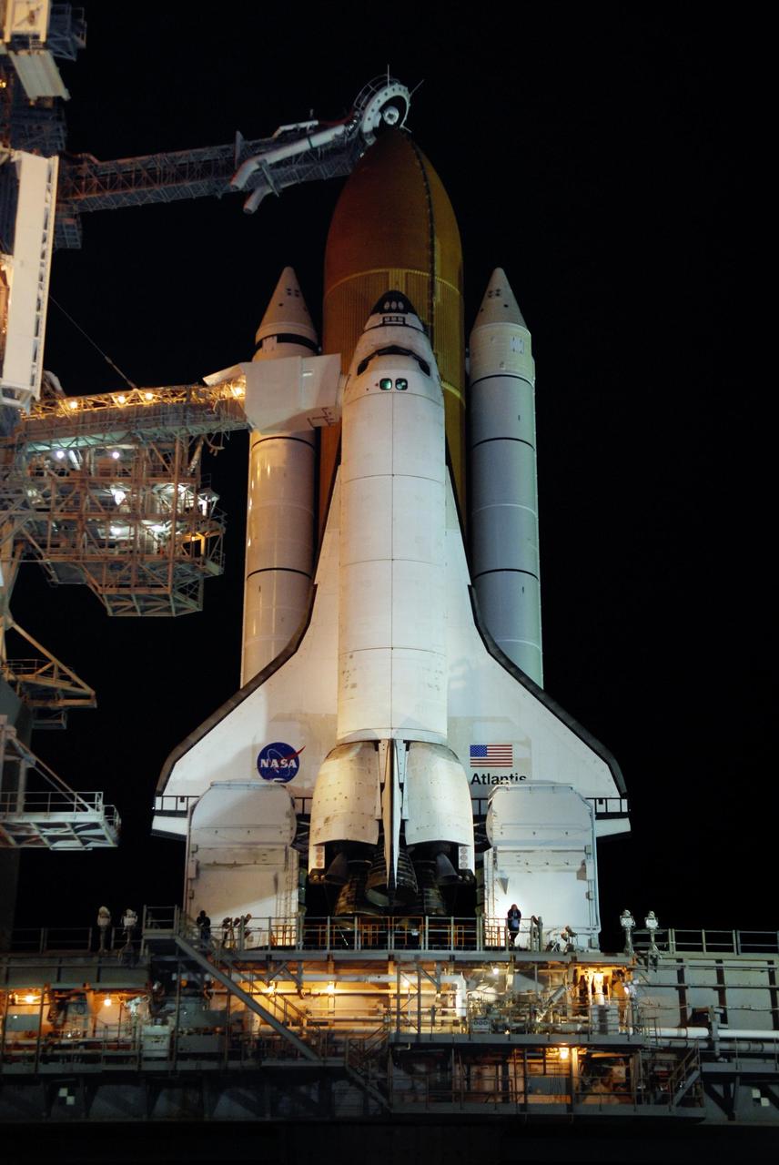 KENNEDY SPACE CENTER, FLA. -- Lights on Launch Pad 39A at NASA's Kennedy Space Center reveal space shuttle Atlantis following the rollback of the rotating service structure, or RSS. Rollback was complete at 8:44 p.m. EST. The orbiter access arm, at left, extends from the structure to a position next to Atlantis' crew compartment. The White Room at the end of the arm provides the crew with an entryway into the orbiter. The RSS also provides protected access to the orbiter for changeout and servicing of payloads at the pad. Rollback of the pad's RSS is one of the milestones in preparation for the launch of mission STS-122, scheduled for 4:31 p.m. EST on Dec. 6. Beneath the shuttle is the mobile launcher platform which supports the shuttle until liftoff. Atlantis will carry the Columbus Laboratory, the European Space Agency's largest contribution to the construction of the International Space Station. It will support scientific and technological research in a microgravity environment. Permanently attached to Node 2 of the space station, the laboratory will carry out experiments in materials science, fluid physics and biosciences, as well as perform a number of technological applications. Photo credit: NASA/Kim Shiflett