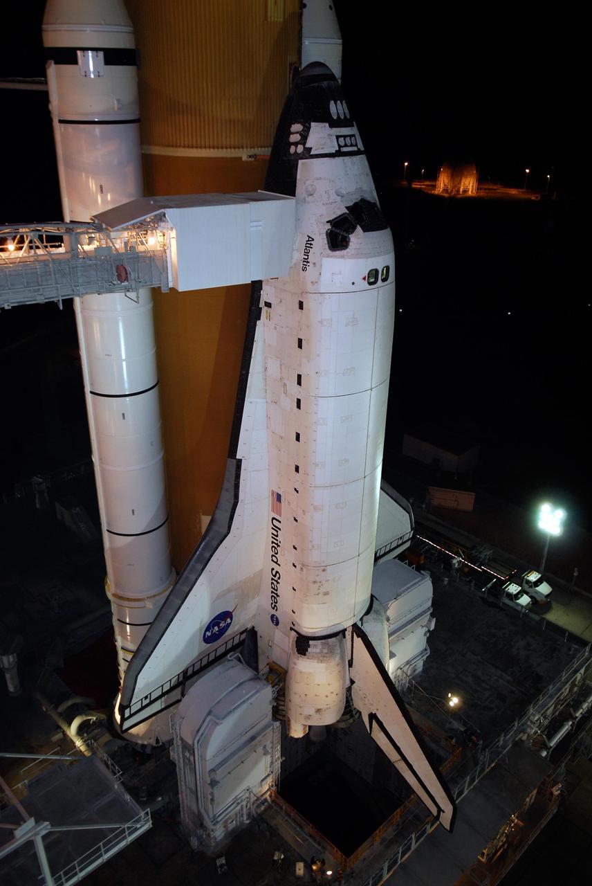 KENNEDY SPACE CENTER, FLA. -- Space shuttle Atlantis is revealed on Launch Pad 39A at NASA's Kennedy Space Center after the rotating service structure, or RSS, is rolled back. Rollback was complete at 8:44 p.m. EST. The White Room at the end of the orbiter access arm, at left, provides the crew with an entryway into the crew compartment. The RSS also provides protected access to the orbiter for changeout and servicing of payloads at the pad. Rollback of the pad's RSS is one of the milestones in preparation for the launch of mission STS-122, scheduled for 4:31 p.m. EST on Dec. 6. Beneath the shuttle is the mobile launcher platform which supports the shuttle until liftoff. Atlantis will carry the Columbus Laboratory, the European Space Agency's largest contribution to the construction of the International Space Station. It will support scientific and technological research in a microgravity environment. Permanently attached to Node 2 of the space station, the laboratory will carry out experiments in materials science, fluid physics and biosciences, as well as perform a number of technological applications. Photo credit: NASA/Kim Shiflett