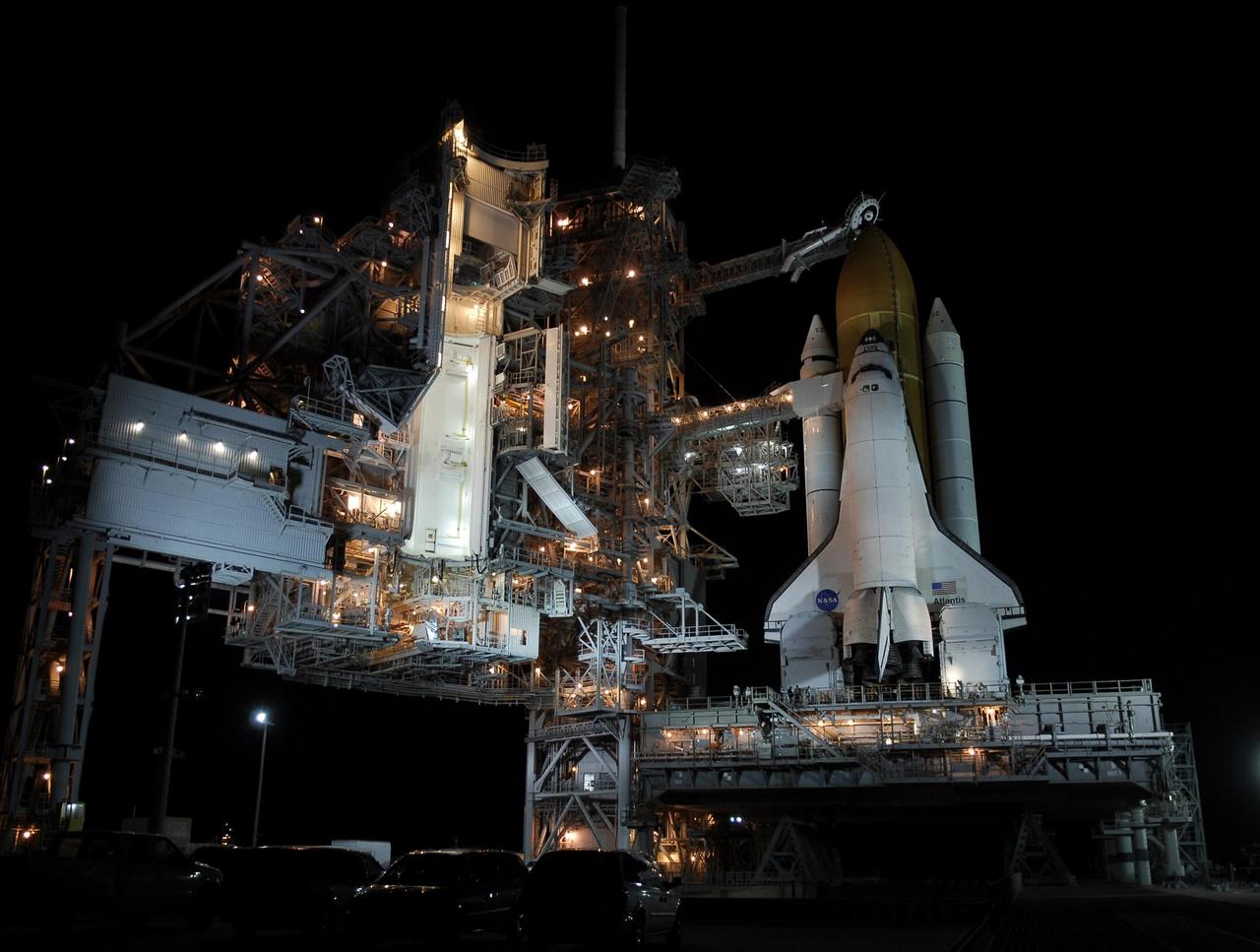 KENNEDY SPACE CENTER, FLA. -- Space shuttle Atlantis is revealed on Launch Pad 39A at NASA's Kennedy Space Center after the rotating service structure, or RSS, at left of the pad is rolled back. Rollback was complete at 8:44 p.m. EST. The RSS provides protected access to the orbiter for crew entry and servicing of payloads at the pad. Rollback of the pad's RSS is one of the milestones in preparation for the launch of mission STS-122, scheduled for 4:31 p.m. EST on Dec. 6.  Beneath the shuttle is the mobile launcher platform which supports the shuttle until liftoff.    Atlantis will carry the Columbus Laboratory, the European Space Agency's largest contribution to the construction of the International Space Station. It will support scientific and technological research in a microgravity environment.  Permanently attached to Node 2 of the space station, the laboratory will carry out experiments in materials science, fluid physics and biosciences, as well as perform a number of technological applications.  Photo credit: NASA/Kim Shiflett