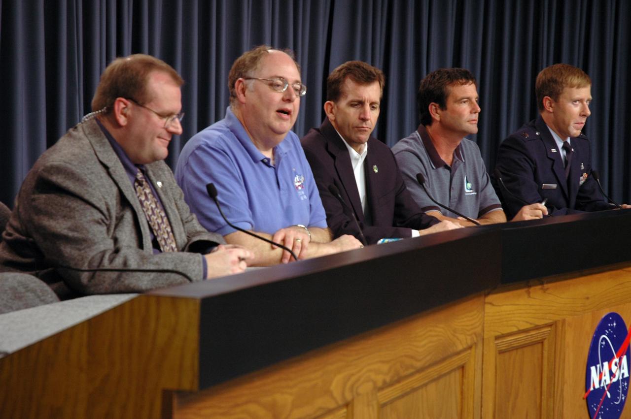 KENNEDY SPACE CENTER, FLA. --  Members of the Mission Management Team, or MMT, participate in a news briefing following the conclusion of the team's meeting.  The meeting continued the discussion of the problems experienced with the space shuttle Atlantis STS-122 external tank's engine cutoff sensor system that arose during tanking on Dec. 6.  From left are Allard Beutel, Kennedy Space Center news chief and briefing moderator; Wayne Hale, Space Shuttle Program manager; LeRoy Cain, MMT chairman; Doug Lyons, STS-122 launch director; and U.S. Air Force Capt. Chris Lovett, 45th Weather Squadron.  An announcement was made during the briefing that the STS-122 launch, originally set for Dec. 6, was rescheduled to 3:21 p.m. Dec. 9.   Atlantis will carry the Columbus Laboratory, the European Space Agency's largest contribution to the construction of the International Space Station. It will support scientific and technological research in a microgravity environment.  Permanently attached to the Harmony node of the space station, the laboratory will carry out experiments in materials science, fluid physics and biosciences, as well as perform a number of technological applications.  Photo credit: NASA/Cory Huston