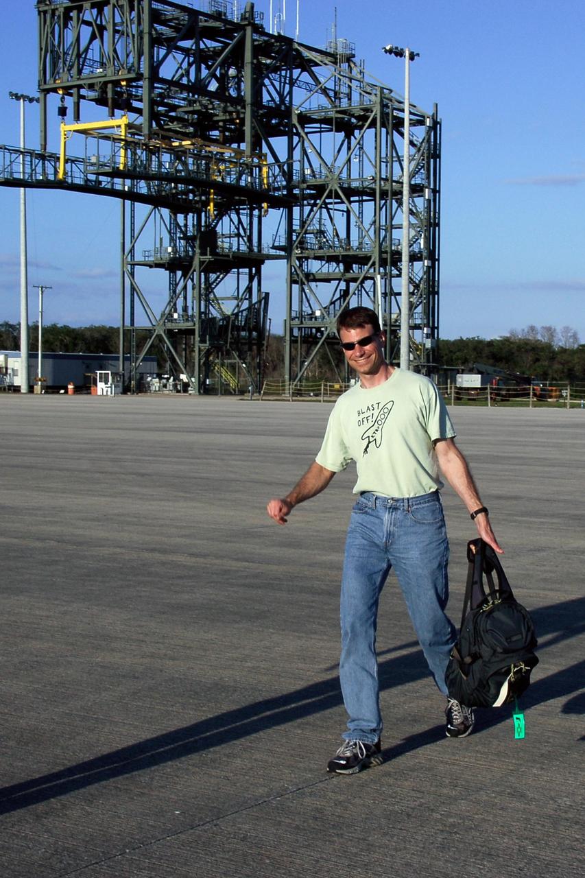 KENNEDY SPACE CENTER, FLA. --  On the Shuttle Landing Facility at NASA's Kennedy Space Center, STS-122 Mission Specialist Stanley Love heads for the plane for the return trip to Houston.  The crew is flying back to Houston after launch of space shuttle Atlantis was delayed when a failure occurred in a fuel sensor system while the vehicle's  external fuel tank was being filled.  One of the four engine cutoff, or ECO, sensors inside the liquid hydrogen section of the tank gave a false reading and NASA's current Launch Commit Criteria require that all four sensors function properly. The sensor system is one of several that protect the shuttle's main engines by triggering their shut down if fuel runs unexpectedly low.  Space shuttle Atlantis' STS-122 mission now is targeted to launch no earlier than Jan. 2. The liftoff date depends on the resolution of the problem in the fuel sensor system.  Photo credit: NASA/Kim Shiflett