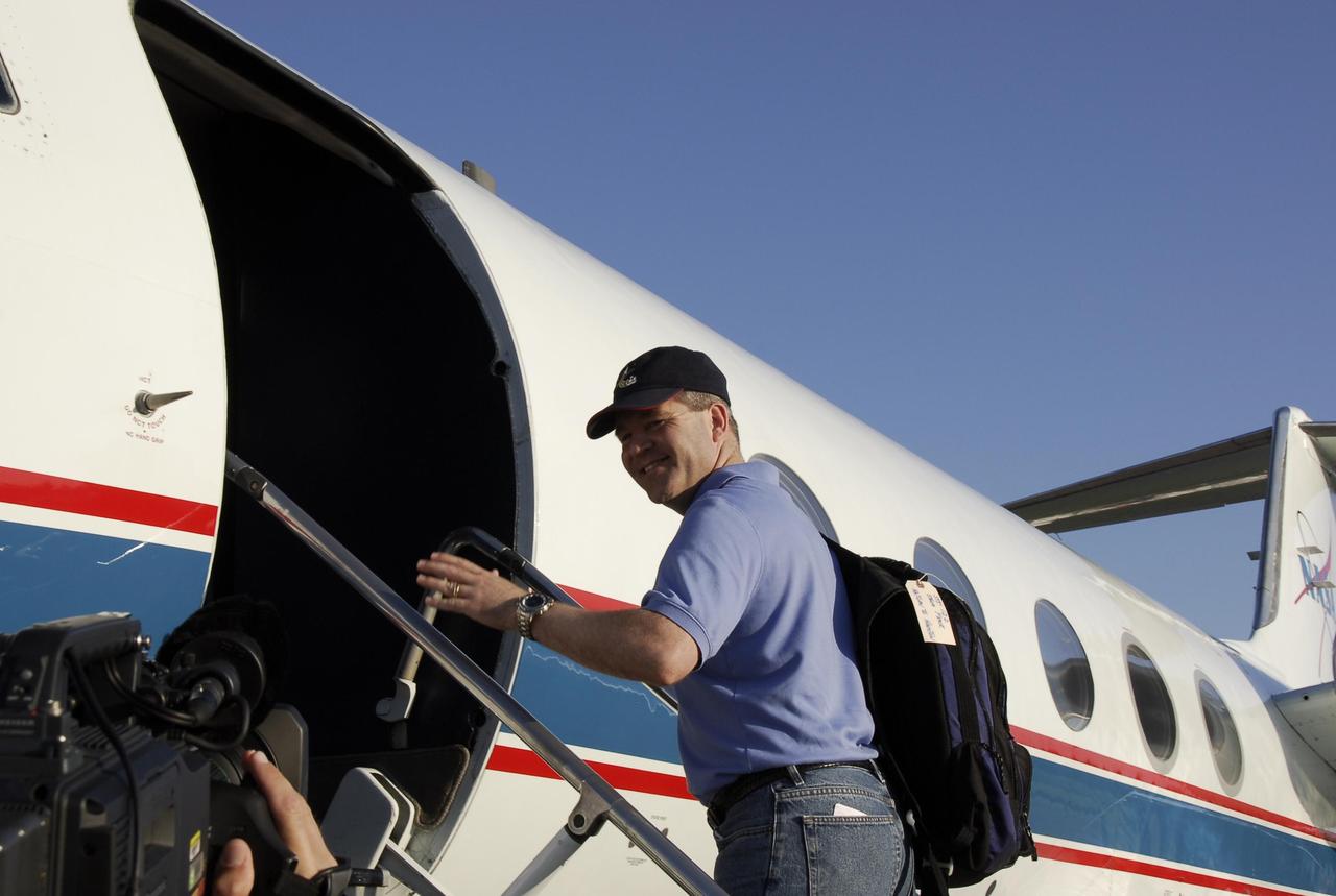 KENNEDY SPACE CENTER, FLA. --   On the Shuttle Landing Facility at NASA's Kennedy Space Center, STS-122 Commander Steve Frick heads for the plane for the return trip to Houston.  The crew is flying back to Houston after launch of space shuttle Atlantis was delayed when a failure occurred in a fuel sensor system while the vehicle's  external fuel tank was being filled. One of the four engine cutoff, or ECO, sensors inside the liquid hydrogen section of the tank gave a false reading and NASA's current Launch Commit Criteria require that all four sensors function properly. The sensor system is one of several that protect the shuttle's main engines by triggering their shut down if fuel runs unexpectedly low.  Space shuttle Atlantis' STS-122 mission now is targeted to launch no earlier than Jan. 2. The liftoff date depends on the resolution of the problem in the fuel sensor system.  Photo credit: NASA/Kim Shiflett