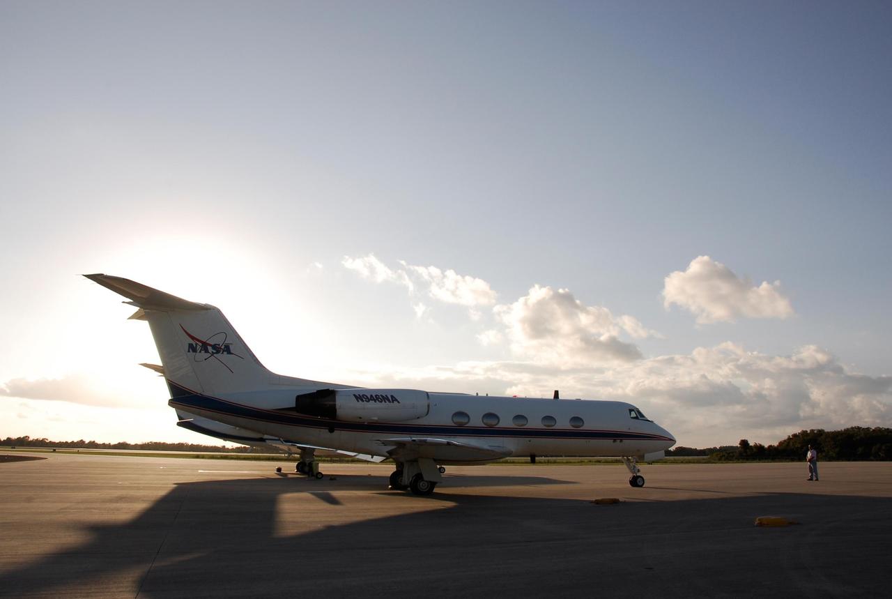 KENNEDY SPACE CENTER, FLA. --    On the Shuttle Landing Facility at NASA's Kennedy Space Center, the plane carrying the STS-122 crew taxis toward the runway for the return trip to Houston.  The crew is flying back to Houston after launch of space shuttle Atlantis was delayed when a failure occurred in a fuel sensor system while the vehicle's  external fuel tank was being filled.  One of the four engine cutoff, or ECO, sensors inside the liquid hydrogen section of the tank gave a false reading and NASA's current Launch Commit Criteria require that all four sensors function properly. The sensor system is one of several that protect the shuttle's main engines by triggering their shut down if fuel runs unexpectedly low.  Space shuttle Atlantis' STS-122 mission now is targeted to launch no earlier than Jan. 2. The liftoff date depends on the resolution of the problem in the fuel sensor system.  Photo credit: NASA/Kim Shiflett