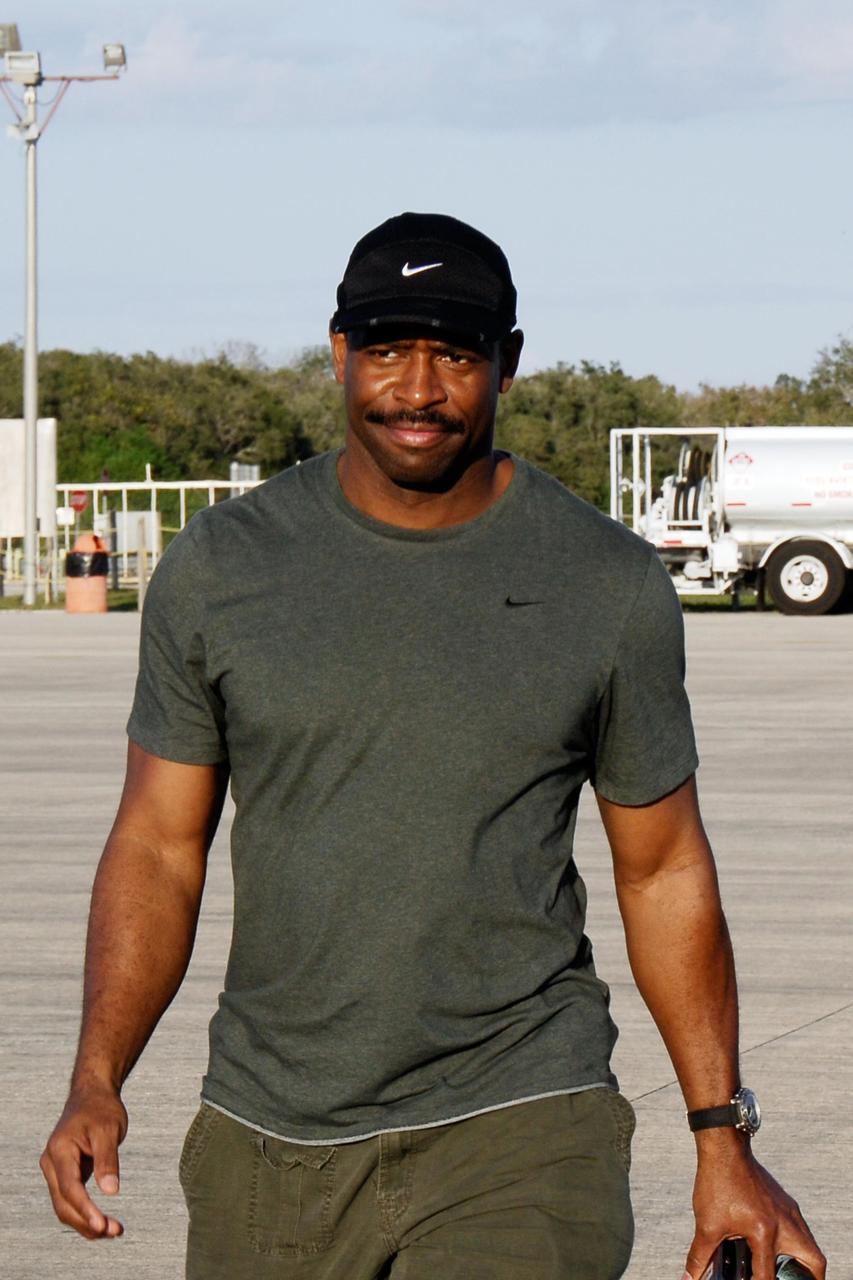 KENNEDY SPACE CENTER, FLA. --     On the Shuttle Landing Facility at NASA's Kennedy Space Center, STS-122 Mission Specialist Leland Melvin heads for the plane for the return trip to Houston.  The crew is flying back to Houston after launch of space shuttle Atlantis was delayed when a failure occurred in a fuel sensor system while the vehicle's  external fuel tank was being filled.  One of the four engine cutoff, or ECO, sensors inside the liquid hydrogen section of the tank gave a false reading and NASA's current Launch Commit Criteria require that all four sensors function properly. The sensor system is one of several that protect the shuttle's main engines by triggering their shut down if fuel runs unexpectedly low.  Space shuttle Atlantis' STS-122 mission now is targeted to launch no earlier than Jan. 2. The liftoff date depends on the resolution of the problem in the fuel sensor system.  Photo credit: NASA/Kim Shiflett