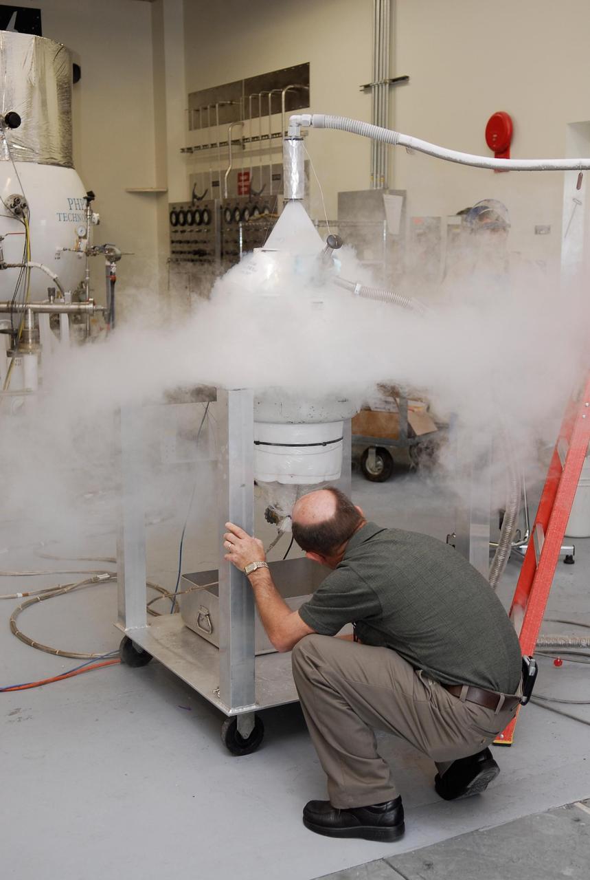 KENNEDY SPACE CENTER, FLA.  --  In the cryogenic test bed facility at NASA's Kennedy Space Center, Time Domain Reflectometry, or TDR, instrumentation is being exposed to "wet" super-cold temperatures for identifying the signature of a cryogenic environment and calibrating the TDR equipment.  The equipment will be used at the launch pad to test a procedure identical to a tanking test on space shuttle Atlantis' external tank planned for Dec. 18.  The shuttle's planned launches on Dec. 6 and Dec. 9 were postponed because of false readings from the part of the engine cut-off, or ECO, sensor system that monitors the liquid hydrogen section of the tank. The liftoff date from NASA's Kennedy Space Center, Florida, is now targeted for Jan. 10, depending on the resolution of the problem in the fuel sensor system.  Photo credit: NASA/Kim Shiflett
