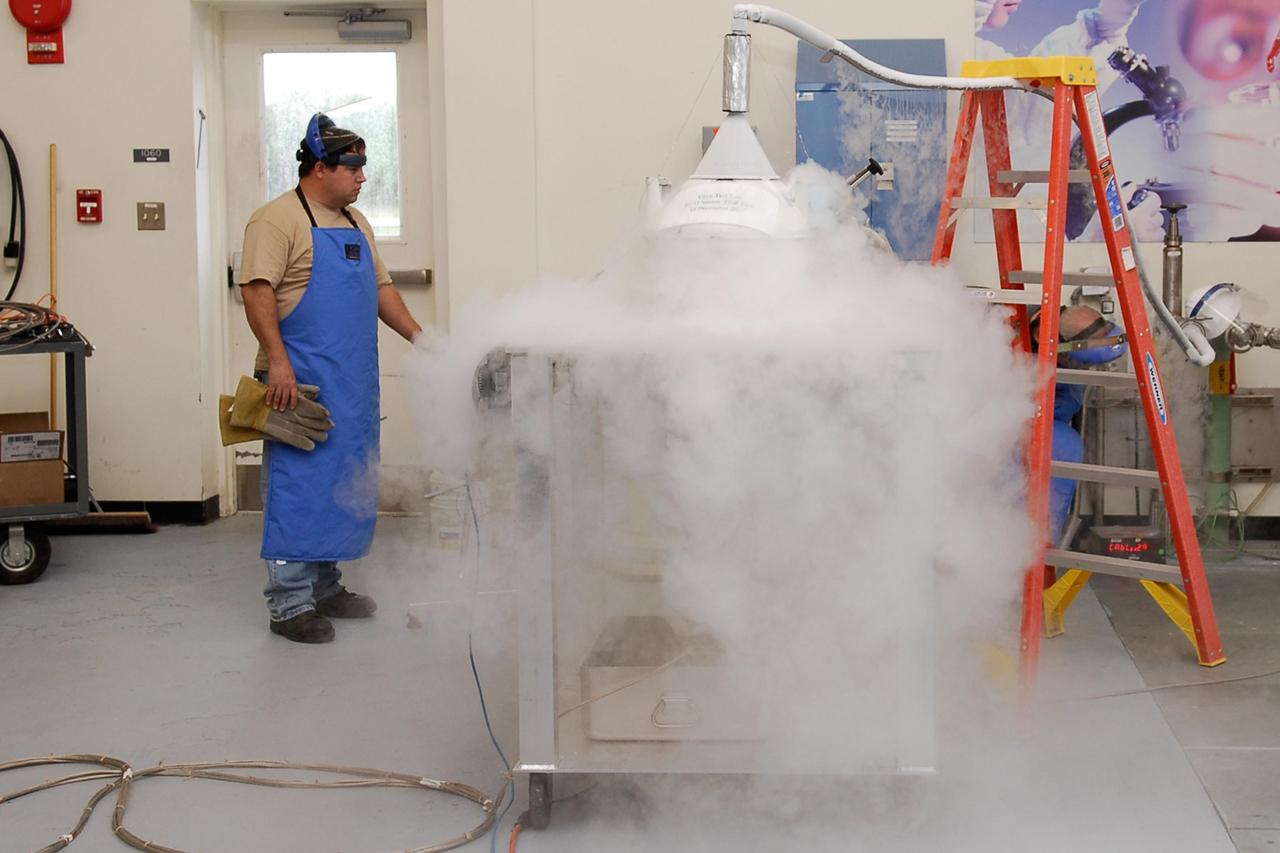 KENNEDY SPACE CENTER, FLA.  --  In the cryogenic test bed facility at NASA's Kennedy Space Center, Time Domain Reflectometry, or TDR, instrumentation is being exposed to "wet" super-cold temperatures for identifying the signature of a cryogenic environment and calibrating the TDR equipment.  The equipment will be used at the launch pad to test a procedure identical to a tanking test on space shuttle Atlantis' external tank planned for Dec. 18.  The shuttle's planned launches on Dec. 6 and Dec. 9 were postponed because of false readings from the part of the engine cut-off, or ECO, sensor system that monitors the liquid hydrogen section of the tank. The liftoff date from NASA's Kennedy Space Center, Florida, is now targeted for Jan. 10, depending on the resolution of the problem in the fuel sensor system.  Photo credit: NASA/Kim Shiflett