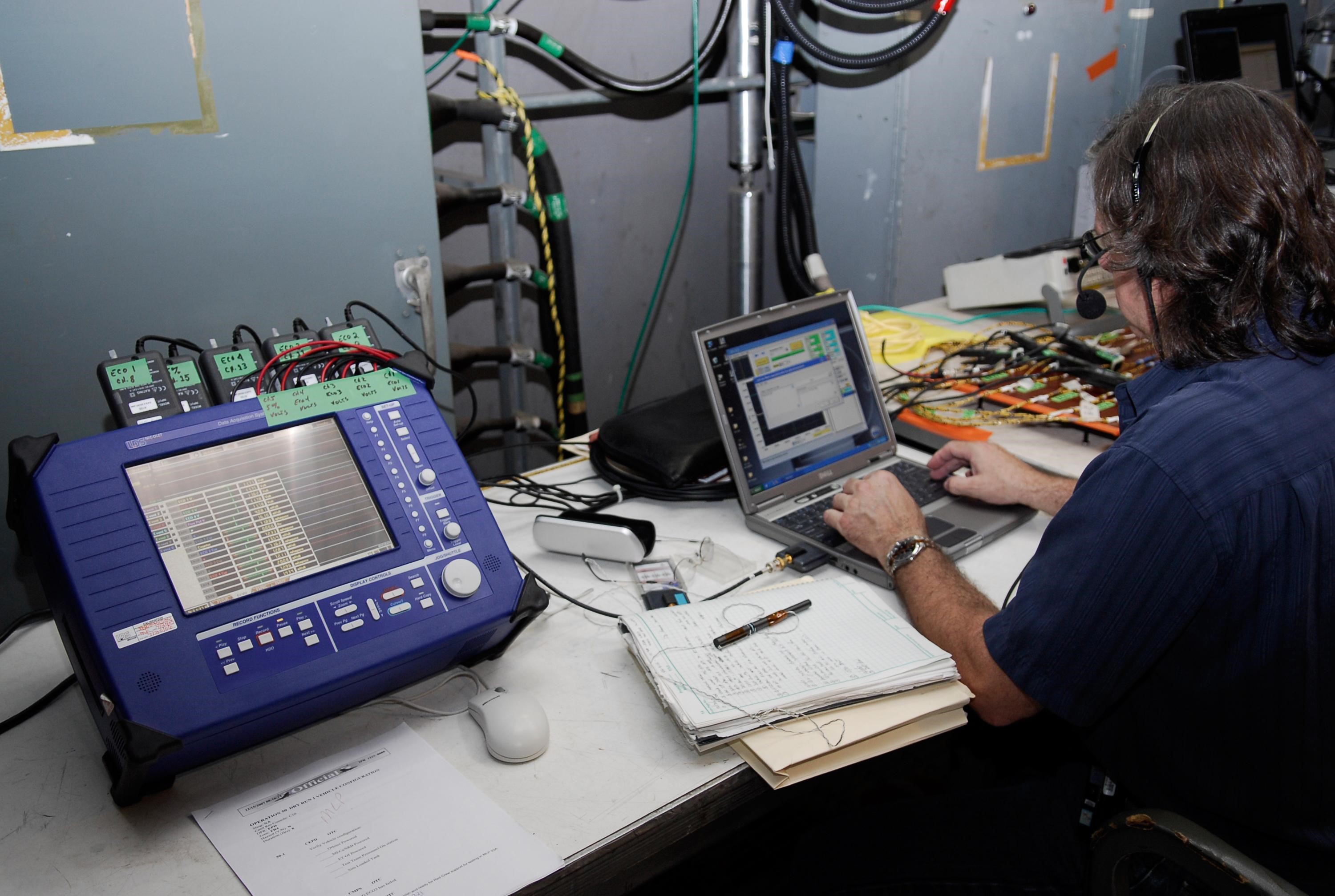KENNEDY SPACE CENTER, FLA.  --  On Launch Pad 39A at NASA's Kennedy Space Center, the wiring is checked and validated before the tanking test on space shuttle Atlantis' external tank set for Dec. 18.  The test wiring has been spliced into an electrical harness in the aft main engine compartment connected with the engine cut-off, or ECO, sensor system. The attached wiring leads to the interior of the mobile launcher platform where the time domain reflectometry, or TDR,  test equipment is located.  Photo credit: NASA/Kim Shiflett