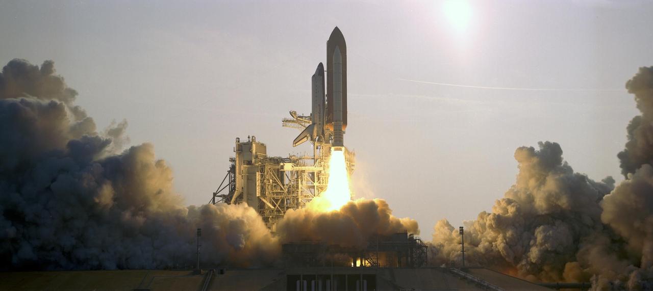 KENNEDY SPACE CENTER, FLA. -- Space Shuttle Endeavour climbs past the fixed service structure on Launch Pad 39A as it begins its journey on mission STS-118. Liftoff from Launch Pad 39A was on time at 6:36 p.m. EDT. The 22nd shuttle flight to the International Space Station, the mission will continue space station construction by delivering a third starboard truss segment, S5, and other payloads such as the SPACEHAB module and the external stowage platform 3. Photo credit: Rick Wetherington, Tim Powers, Don Kight