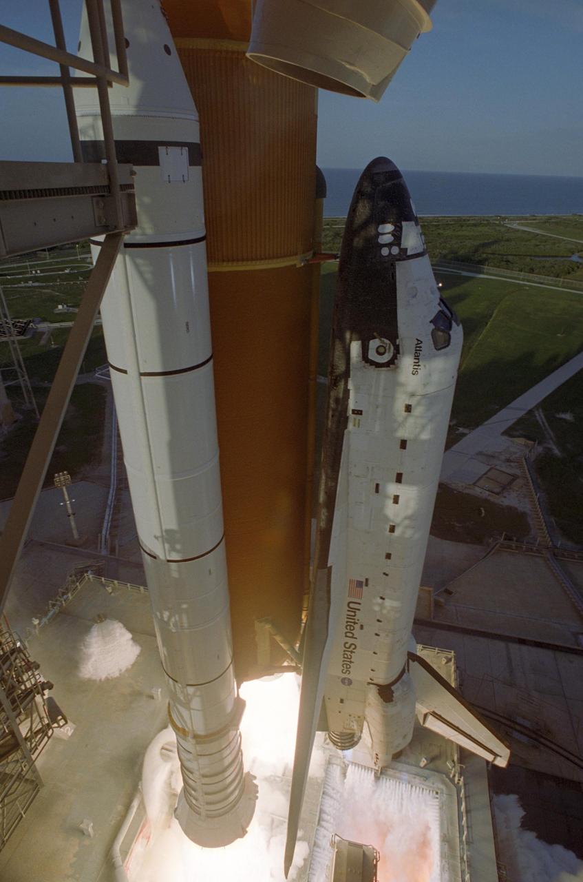 KENNEDY SPACE CENTER, FLA. -- Space Shuttle Atlantis is captured as it lifts off Launch Pad 39A for a rocket ride into the sky and rendezvous with the International Space Station on mission STS-117. On the mobile launcher platform below Atlantis can be seen the jets of water flooding the surface for sound suppression. Beyond the pad on the horizon is the Atlantic Ocean. Liftoff of Atlantis was on-time at 7:38:04 p.m. EDT. The shuttle is delivering a new segment to the starboard side of the International Space Station's backbone, known as the truss. Three spacewalks are planned to install the S3/S4 truss segment, deploy a set of solar arrays and prepare them for operation. STS-117 is the 118th space shuttle flight, the 21st flight to the station, the 28th flight for Atlantis and the first of four flights planned for 2007. Photo Credit: NASA/Tony Gray & Rick Wetherington