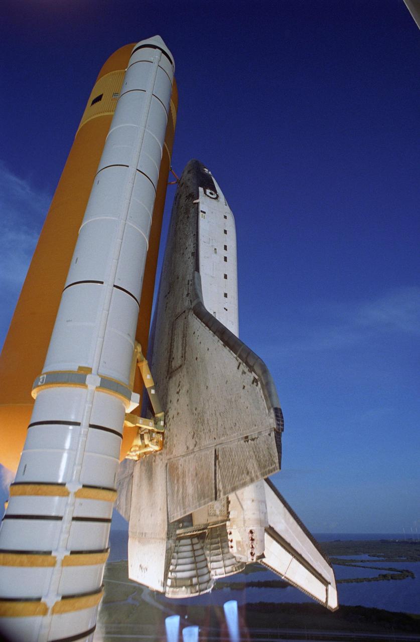 KENNEDY SPACE CENTER, FLA. --   Space Shuttle Atlantis rockets into the blue sky above Launch Pad 39A after liftoff.  Beneath Atlantis' main engines are blue cones of light, known as shock or mach diamonds.   They are a formation of shock waves in the exhaust plume of an aerospace propulsion system. Liftoff of Atlantis on mission STS-117 to the International Space Station was on time at 7:38:04 p.m. EDT. The shuttle is delivering a new segment to the starboard side of the International Space Station's backbone, known as the truss. Three spacewalks are planned to install the S3/S4 truss segment, deploy a set of solar arrays and prepare them for operation. STS-117 is the 118th space shuttle flight, the 21st flight to the station, the 28th flight for Atlantis and the first of four flights planned for 2007. Photo Credit:  NASA/Tony Gray & Don Kight
