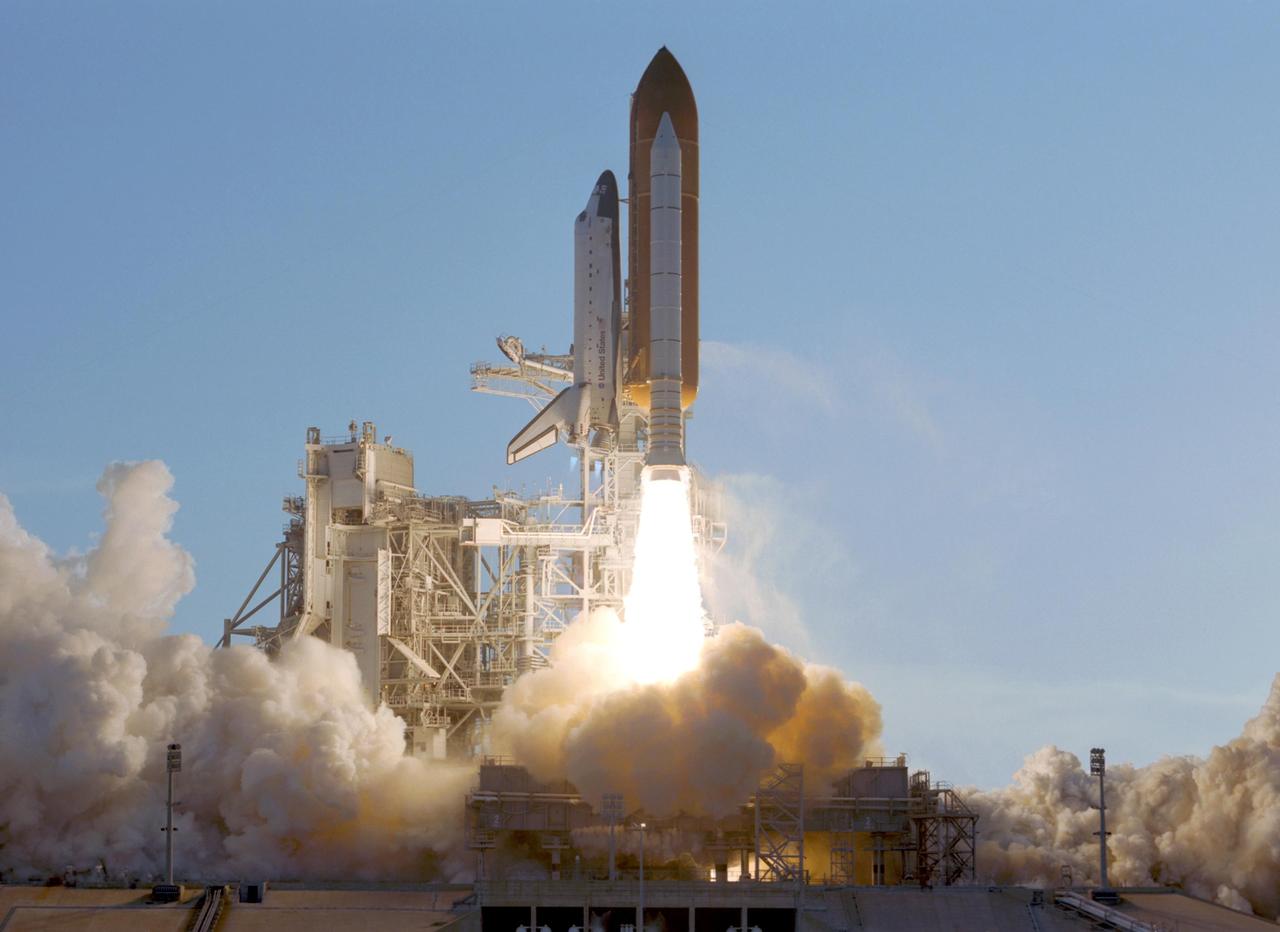 KENNEDY SPACE CENTER, FLA. --  With solid rocket boosters firing, Space Shuttle Atlantis leaps toward the heavens in a near-perfect launch on mission STS-117 to the International Space Station.  The clouds of smoke and steam roll across Launch Pad 39A and surround the rotating service structure at left. Liftoff was on-time at 7:38:04 p.m. EDT. The shuttle is delivering a new segment to the starboard side of the International Space Station's backbone, known as the truss. Three spacewalks are planned to install the S3/S4 truss segment, deploy a set of solar arrays and prepare them for operation. STS-117 is the 118th space shuttle flight, the 21st flight to the station, the 28th flight for Atlantis and the first of four flights planned for 2007.  Photo credit: NASA/Jerry Cannon & Mike Kerley