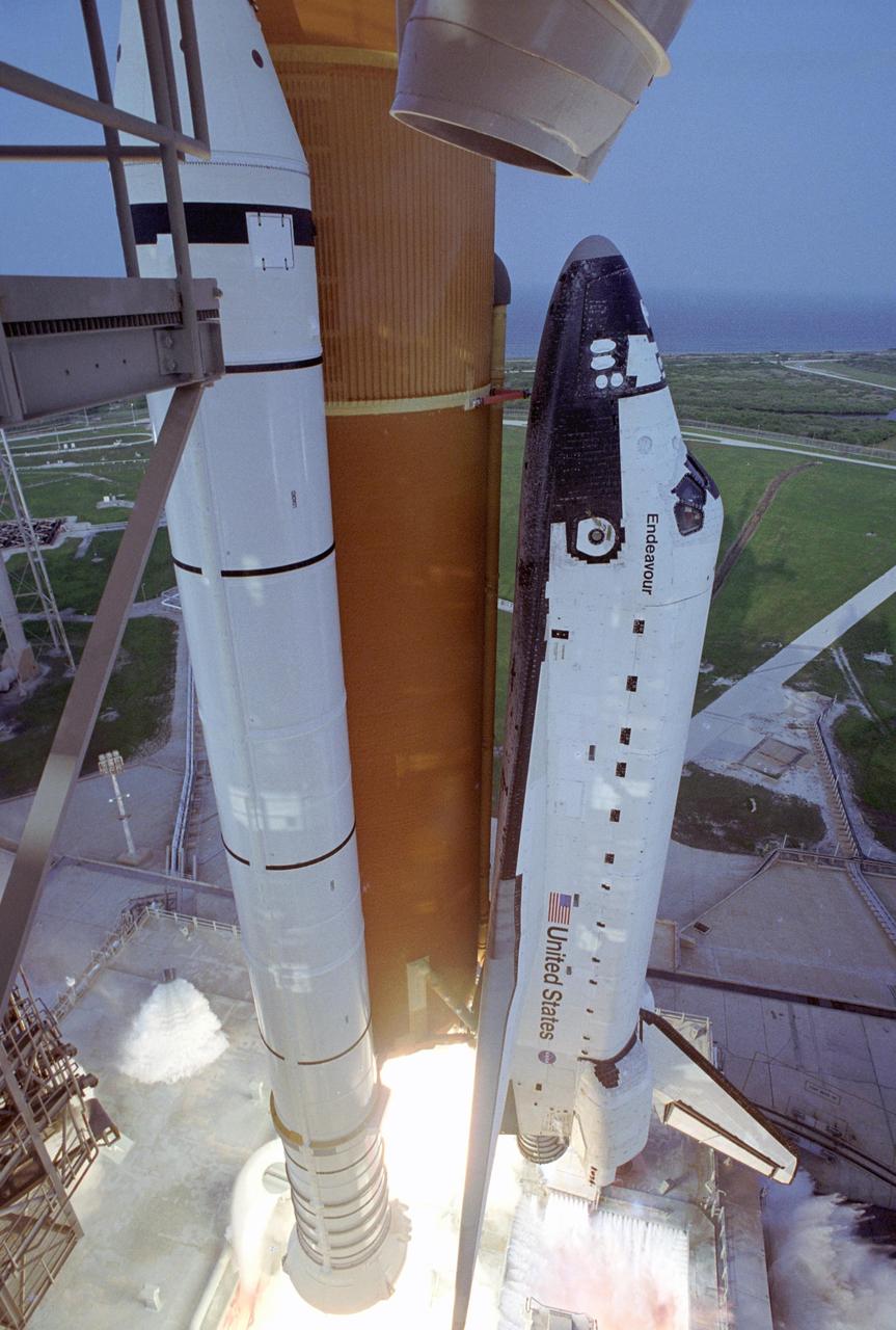 KENNEDY SPACE CENTER, FLA. -- As Space Shuttle Endeavour lifts off from Launch Pad 39A on mission STS-118, water pours over the mobile launcher platform below for sound suppression. The 22nd shuttle flight to the International Space Station, the mission will continue space station construction by delivering a third starboard truss segment, S5, and other payloads such as the SPACEHAB module and the external stowage platform 3. Liftoff of Endeavour was on time at 6:36 p.m. EDT. Photo credit: NASA/John Kechele, Scott Haun, Tom Farrar