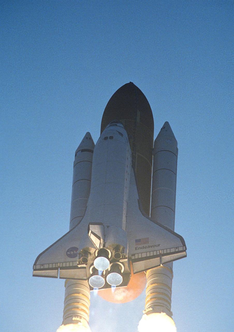 KENNEDY SPACE CENTER, FLA. -- Blue mach diamonds appear beneath the main engines on Space Shuttle Endeavour as it hurtles into the sky on mission STS-118. The 22nd shuttle flight to the International Space Station, the mission will continue space station construction by delivering a third starboard truss segment, S5, and other payloads such as the SPACEHAB module and the external stowage platform 3. Liftoff of Endeavour was on time at 6:36 p.m. EDT. Photo credit: NASA/Jerry Cannon, Mike Kerley
