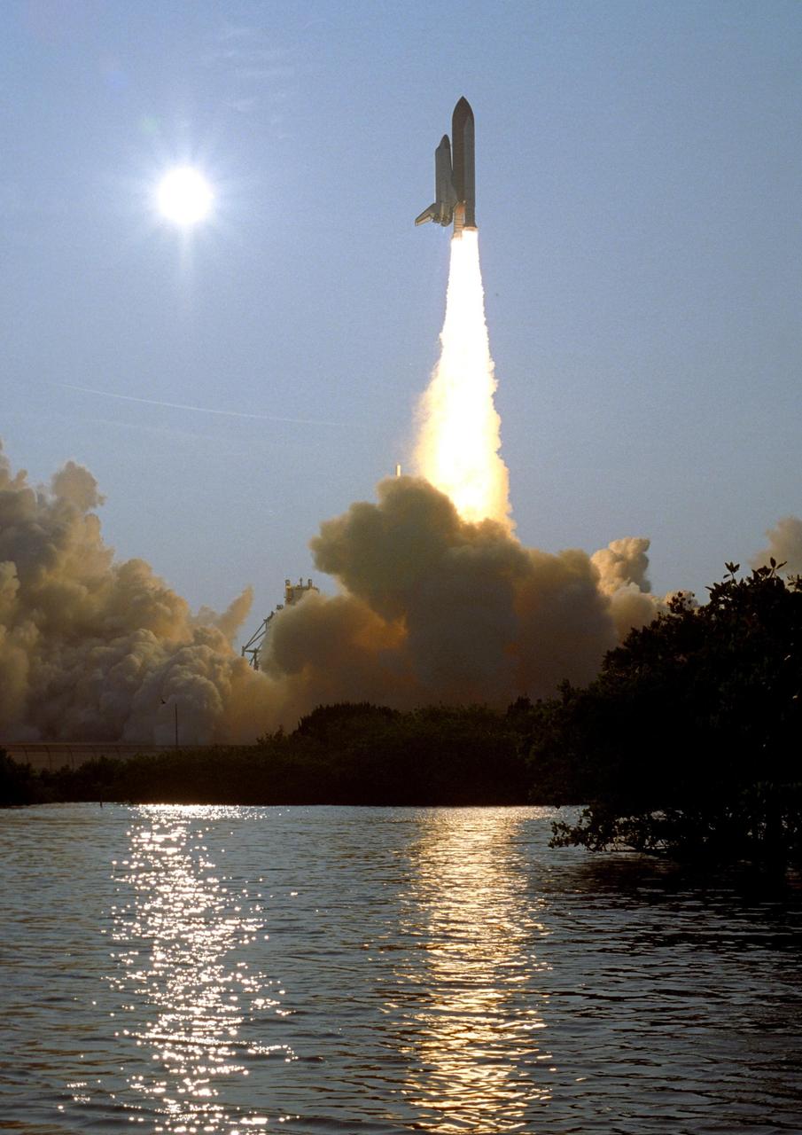 KENNEDY SPACE CENTER, FLA. -- The water near Launch Pad 39A captures the brilliance of both the setting sun, at left, and Space Shuttle Endeavour as it hurtles into space on mission STS-118. The 22nd shuttle flight to the International Space Station, the mission will continue space station construction by delivering a third starboard truss segment, S5, and other payloads such as the SPACEHAB module and the external stowage platform 3. Liftoff of Endeavour was on time at 6:36 p.m. EDT. Photo credit: NASA/Sandra Joseph, Tony Gray, Robert Murray