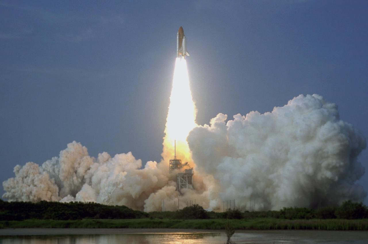 KENNEDY SPACE CENTER, FLA. -- Clouds of smoke and steam fill Launch Pad 39A after liftoff of Space Shuttle Endeavour, trailing a fiery tail, on mission STS-118. The 22nd shuttle flight to the International Space Station, the mission will continue space station construction by delivering a third starboard truss segment, S5, and other payloads such as the SPACEHAB module and the external stowage platform 3. Liftoff of Endeavour was on time at 6:36 p.m. EDT. Photo credit: NASA/Sandra Joseph, Tony Gray, Robert Murray