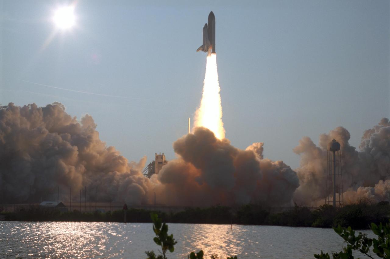 KENNEDY SPACE CENTER, FLA. -- The water near Launch Pad 39A captures the brilliance of both the setting sun, at left, and Space Shuttle Endeavour as it hurtles into space on mission STS-118. The 22nd shuttle flight to the International Space Station, the mission will continue space station construction by delivering a third starboard truss segment, S5, and other payloads such as the SPACEHAB module and the external stowage platform 3. Liftoff of Endeavour was on time at 6:36 p.m. EDT. Photo credit: NASA/Sandra Joseph, Tony Gray, Robert Murray