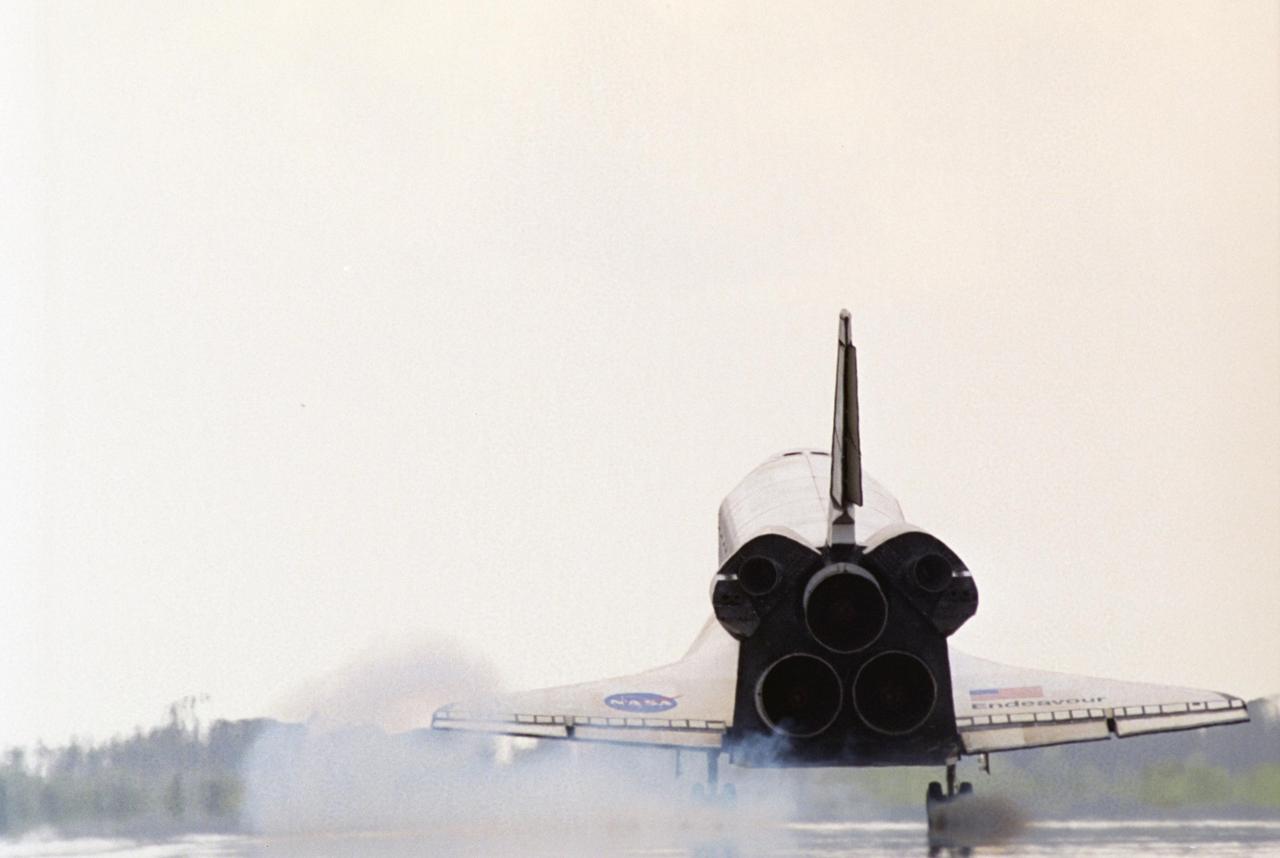 KENNEDY SPACE CENTER, FLA. -- Seen from behind, Endeavour kicks up dust as its wheels touch down on runway 15 at NASA's Kennedy Space Center, completing a 13-day mission to the International Space Station. The STS-118 mission began Aug. 8 and installed a new gyroscope, an external spare parts platform and another truss segment to the expanding station.  Endeavour's main gear touched down at 12:32:16  p.m. EDT.  Nose gear touchdown was at 12:32:29 p.m. and wheel stop was at 12:33:20 p.m.  Endeavour traveled nearly 5.3 million miles, landing on orbit 201.  STS-118 was the 119th space shuttle flight, the 22nd flight to the station, the 20th flight for Endeavour and the second of four missions planned for 2007. This was the 65th landing of an orbiter at Kennedy.  Photo credit: NASA/John Kechele, Scott Haun