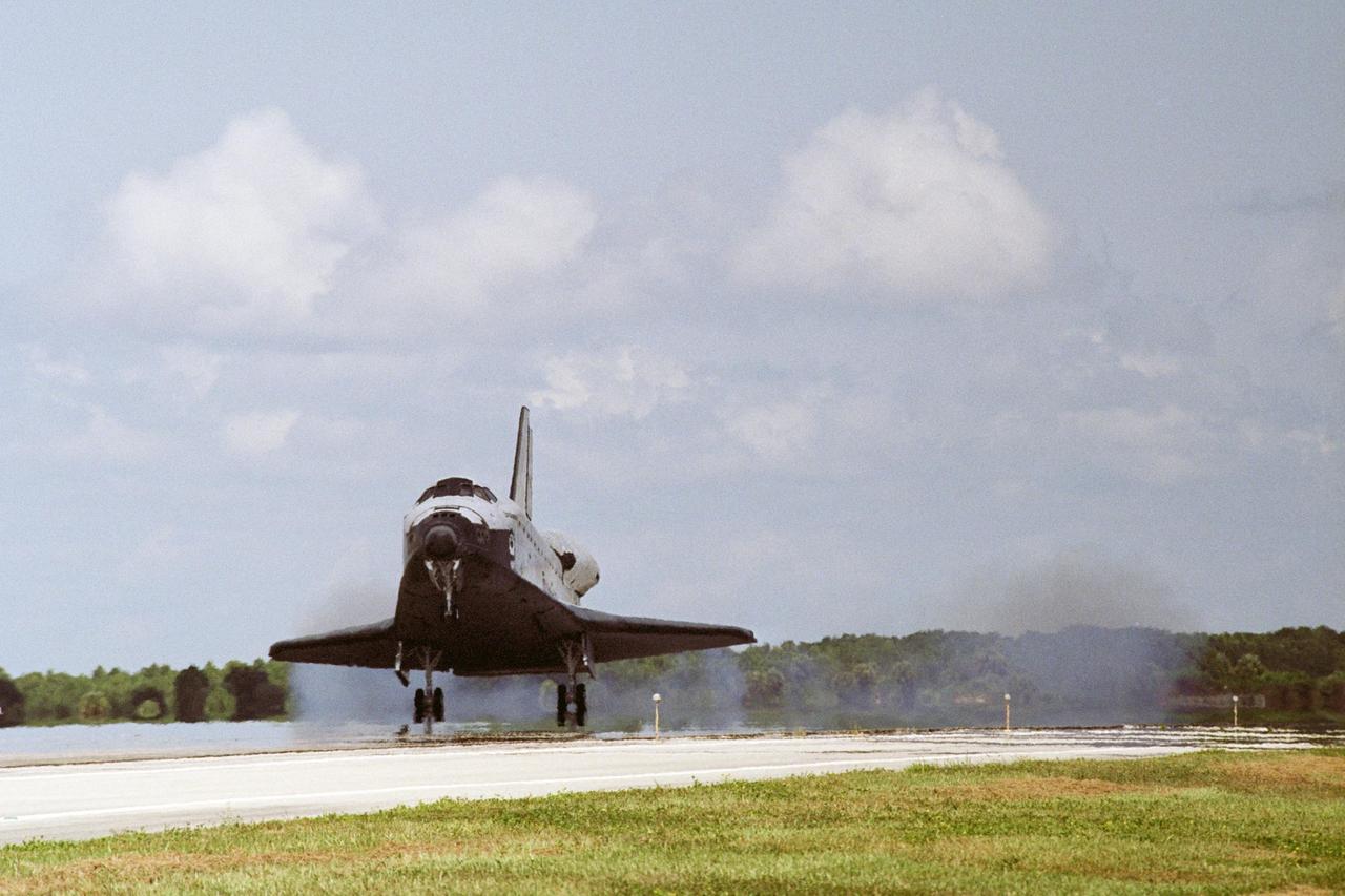 KENNEDY SPACE CENTER, FLA. -- Leaving a trail of dust behind, Endeavour lands on runway 15 at NASA's Kennedy Space Center, completing a 13-day mission to the International Space Station. The STS-118 mission began Aug. 8 and installed a new gyroscope, an external spare parts platform and another truss segment to the expanding station.  Endeavour's main gear touched down at 12:32:16  p.m. EDT.  Nose gear touchdown was at 12:32:29 p.m. and wheel stop was at 12:33:20 p.m.  Endeavour traveled nearly 5.3 million miles, landing on orbit 201.  STS-118 was the 119th space shuttle flight, the 22nd flight to the station, the 20th flight for Endeavour and the second of four missions planned for 2007. This was the 65th landing of an orbiter at Kennedy.  Photo credit: NASA/John Kechele, Scott Haun