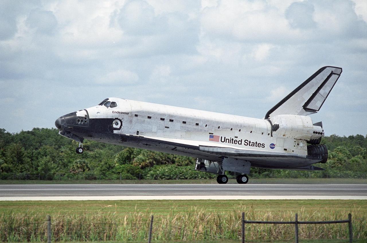 KENNEDY SPACE CENTER, FLA. -- Clouds belie the bright blue sky as Endeavour touches down on runway 15 at NASA's Kennedy Space Center, completing a 13-day mission to the International Space Station. The STS-118 mission began Aug. 8 and installed a new gyroscope, an external spare parts platform and another truss segment to the expanding station. Endeavour's main gear touched down at 12:32:16 p.m. EDT. Nose gear touchdown was at 12:32:29 p.m. and wheel stop was at 12:33:20 p.m. Endeavour traveled nearly 5.3 million miles, landing on orbit 201. STS-118 was the 119th space shuttle flight, the 22nd flight to the station, the 20th flight for Endeavour and the second of four missions planned for 2007. This was the 65th landing of an orbiter at Kennedy. Photo credit: NASA/Tony Gray