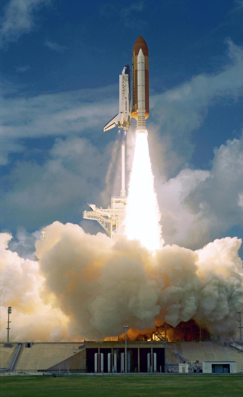 KENNEDY SPACE CENTER, FLA. --  Erupting from the smoke and steam billowing below, space shuttle Discovery clears the lightning mast at left, atop the fixed service structure, and races toward space on mission STS-120 to the International Space Station. Liftoff of Discovery was on time at 11:38:19 a.m. EDT. The mission is the 23rd assembly flight to the space station and the 34th flight for Discovery. The STS-120 payload is the Italian-built U.S. Node 2, called Harmony. During the 14-day mission, the crew will install Harmony and move the P6 solar arrays to their permanent position and deploy them. Discovery is expected to complete its mission and return home at 4:50 a.m. EST on Nov. 6. Photo credit: NASA/Jerry Cannon, Mike Kerley, Don Kight