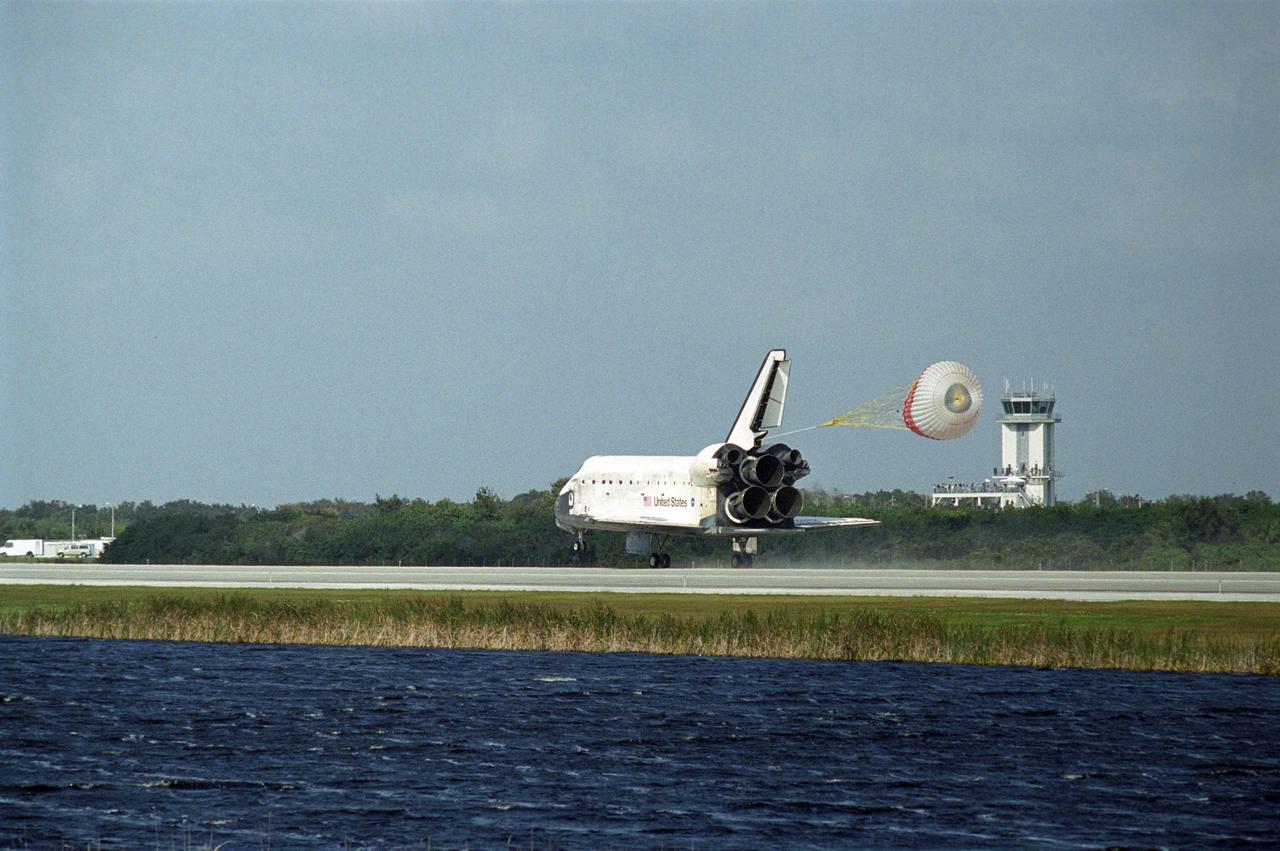 KENNEDY SPACE CENTER, FLA. -- The space shuttle Discovery is slowed by a drag chute behind it as it lands on Runway 33 of the Shuttle Landing Facility at NASA's Kennedy Space Center.  he landing completes the 15-day mission STS-120 to the International Space Station. Main gear touchdown was 1:01:16 p.m.  Wheel stop was at 1:02:07 p.m.  Mission elapsed time was 15 days, 2 hours, 24 minutes and 2 seconds.  During the mission, the STS-120 crew continued the construction of the station with the installation of the Harmony Node 2 module and the relocation of the P6 truss.  Photo credit: NASA/Jerry Cannon, Richard Prickett