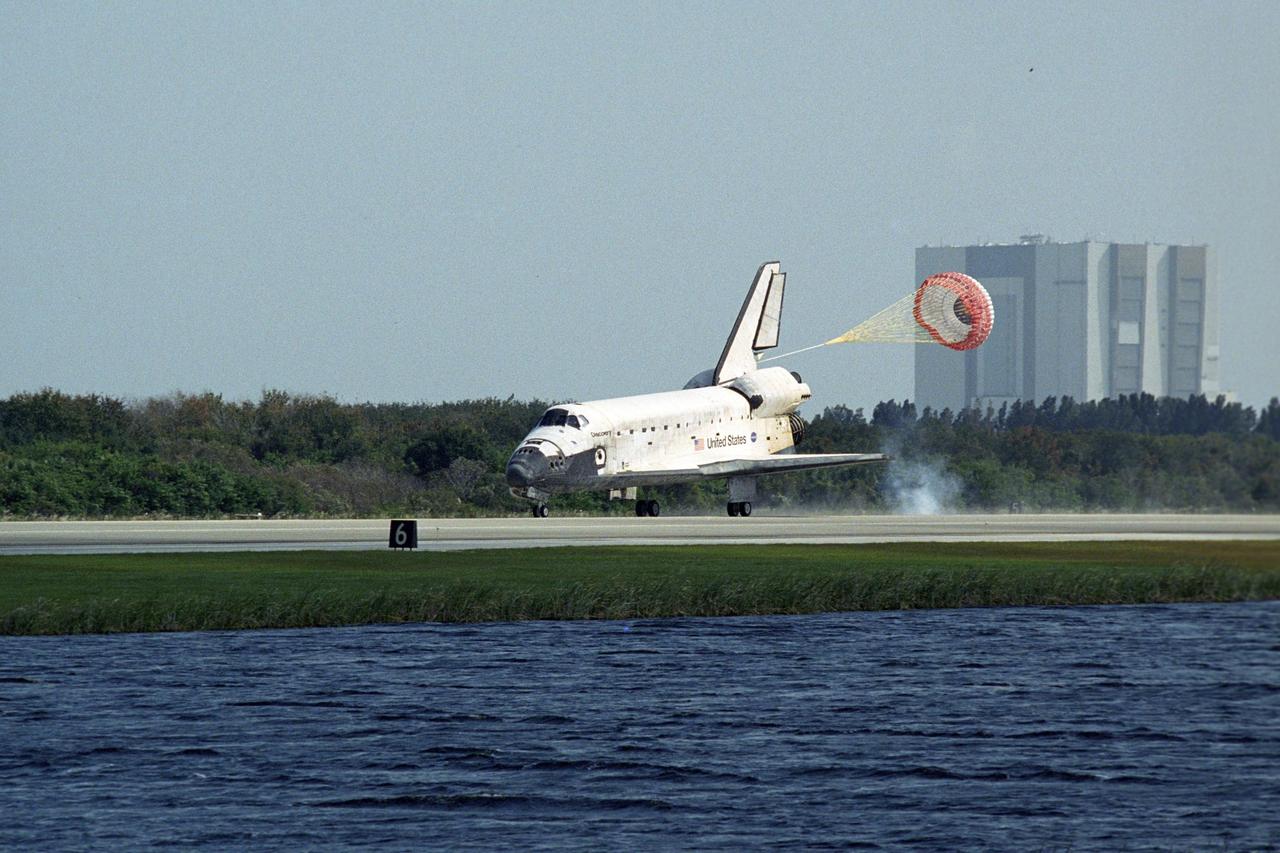 KENNEDY SPACE CENTER, FLA. -- The space shuttle Discovery is slowed by a drag chute behind it as it lands on Runway 33 of the Shuttle Landing Facility at NASA's Kennedy Space Center.  he landing completes the 15-day mission STS-120 to the International Space Station. Main gear touchdown was 1:01:16 p.m.  Wheel stop was at 1:02:07 p.m.  Mission elapsed time was 15 days, 2 hours, 24 minutes and 2 seconds.  During the mission, the STS-120 crew continued the construction of the station with the installation of the Harmony Node 2 module and the relocation of the P6 truss.  Photo credit: NASA/Regina Mitchell-Ryall, Robert Murray