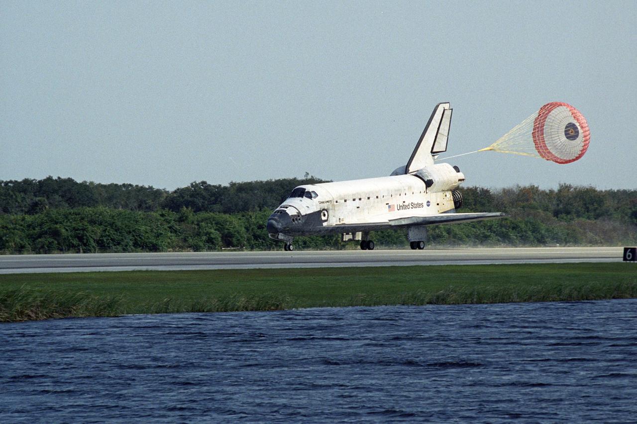 KENNEDY SPACE CENTER, FLA. -- The space shuttle Discovery is slowed by a drag chute behind it as it lands on Runway 33 of the Shuttle Landing Facility at NASA's Kennedy Space Center.  he landing completes the 15-day mission STS-120 to the International Space Station. Main gear touchdown was 1:01:16 p.m.  Wheel stop was at 1:02:07 p.m.  Mission elapsed time was 15 days, 2 hours, 24 minutes and 2 seconds.  During the mission, the STS-120 crew continued the construction of the station with the installation of the Harmony Node 2 module and the relocation of the P6 truss.  Photo credit: NASA/Regina Mitchell-Ryall, Robert Murray