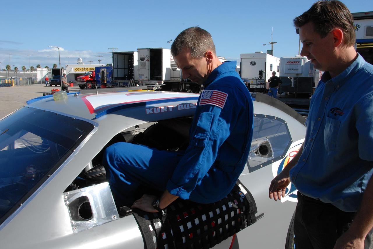 KENNEDY SPACE CENTER, FLA. -- Astronaut Andrew Feustel climbs into the driver's seat of an official track vehicle at Daytona International Speedway. Feustel is participating in NASCAR's Preseason Thunder Fan Fest at the speedway and will ride around the track, taking "hot laps" in the car. Feustel's appearance celebrates NASA's 50th anniversary and the speedway's 50th running of the Daytona 500 in February. Besides the driving experience, Feuster will meet with fans and the media. The NASA/NASCAR association spans decades. Technology developed for the space program has helped NASCAR drivers increase their performance and stay safe over the years. They wear cooling suits similar to what astronauts wear during a spacewalk. Foam that NASA developed for aircraft seats protects racecar drivers' necks in crashes. In addition to participating in the fan festival, NASA will fly three Daytona 500 flags aboard an upcoming space shuttle flight. Speedway officials plan to wave one of the flags to begin the 2008 installment of the Daytona 500, while another will be presented to the winning driver. NASA will keep the third. Feustel will fly on the space shuttle mission STS-125 to the Hubble Space Telescope. The mission will extend and improve the observatory's capabilities through 2013. Launch is targeted for August 2008. Photo credit: NASA/George Shelton