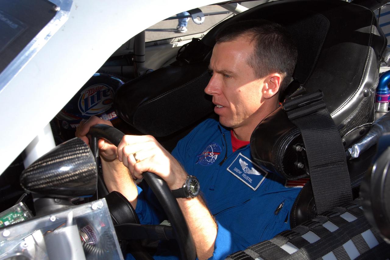KENNEDY SPACE CENTER, FLA. -- Astronaut Andrew Feustel gets adjusted to the driver's seat in an official track vehicle at Daytona International Speedway. Feustel is participating in NASCAR's Preseason Thunder Fan Fest at the speedway and will ride around the track, taking "hot laps" in the car. Feustel's appearance celebrates NASA's 50th anniversary and the speedway's 50th running of the Daytona 500 in February. Besides the driving experience, Feuster will meet with fans and the media. The NASA/NASCAR association spans decades. Technology developed for the space program has helped NASCAR drivers increase their performance and stay safe over the years. They wear cooling suits similar to what astronauts wear during a spacewalk. Foam that NASA developed for aircraft seats protects racecar drivers' necks in crashes. In addition to participating in the fan festival, NASA will fly three Daytona 500 flags aboard an upcoming space shuttle flight. Speedway officials plan to wave one of the flags to begin the 2008 installment of the Daytona 500, while another will be presented to the winning driver. NASA will keep the third. Feustel will fly on the space shuttle mission STS-125 to the Hubble Space Telescope. The mission will extend and improve the observatory's capabilities through 2013. Launch is targeted for August 2008. Photo credit: NASA/George Shelton