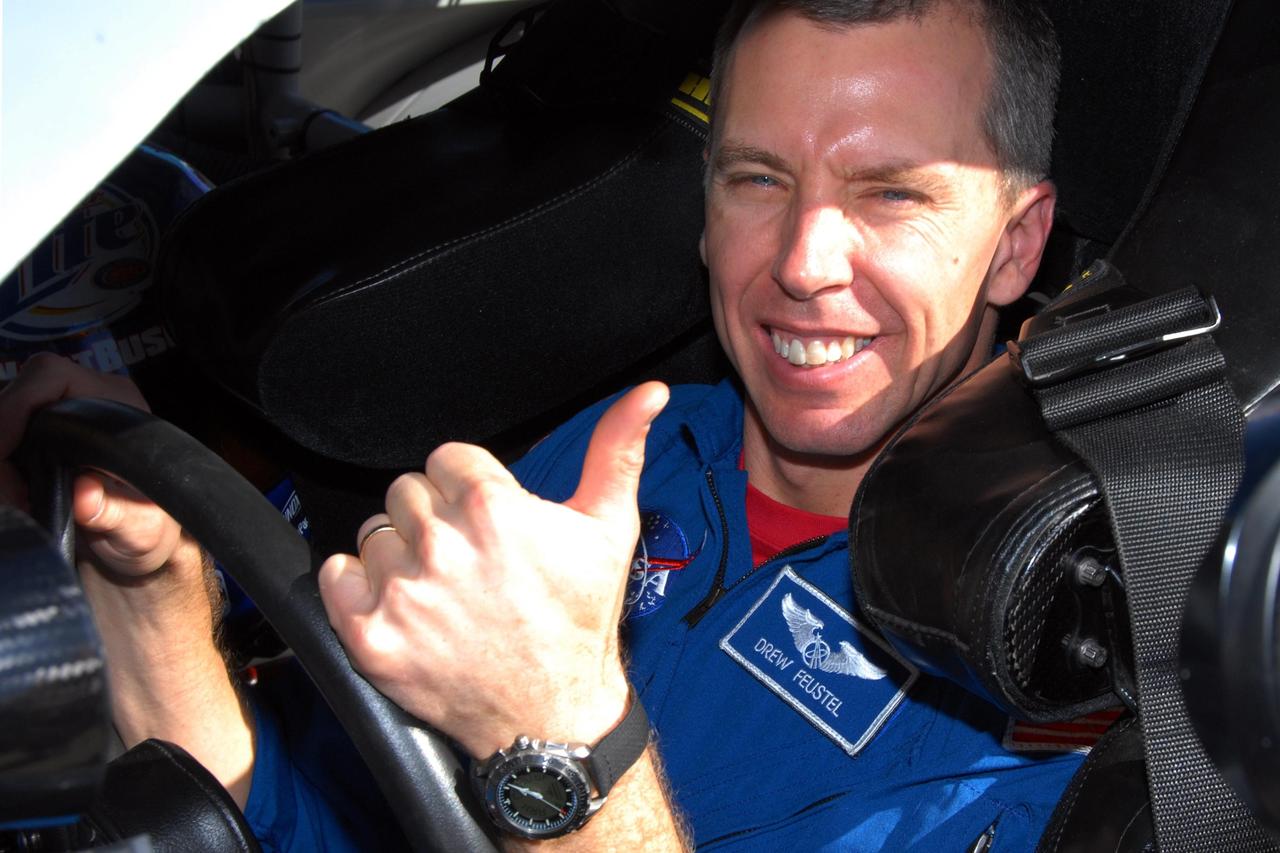 KENNEDY SPACE CENTER, FLA. -- Astronaut Andrew Feustel is ready for his ride in an official track vehicle at Daytona International Speedway. Feustel is participating in NASCAR's Preseason Thunder Fan Fest at the speedway and will ride around the track, taking "hot laps" in the car. Feustel's appearance celebrates NASA's 50th anniversary and the speedway's 50th running of the Daytona 500 in February. Besides the driving experience, Feuster will meet with fans and the media. The NASA/NASCAR association spans decades. Technology developed for the space program has helped NASCAR drivers increase their performance and stay safe over the years. They wear cooling suits similar to what astronauts wear during a spacewalk. Foam that NASA developed for aircraft seats protects racecar drivers' necks in crashes. In addition to participating in the fan festival, NASA will fly three Daytona 500 flags aboard an upcoming space shuttle flight. Speedway officials plan to wave one of the flags to begin the 2008 installment of the Daytona 500, while another will be presented to the winning driver. NASA will keep the third. Feustel will fly on the space shuttle mission STS-125 to the Hubble Space Telescope. The mission will extend and improve the observatory's capabilities through 2013. Launch is targeted for August 2008. Photo credit: NASA/George Shelton