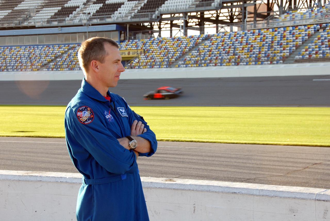 KENNEDY SPACE CENTER, FLA. -- Astronaut Andrew Feustel watches other cars on the Daytona International Speedway. Feustel had his turn at riding around the track, taking "hot laps" in an official track vehicle. Feustel is participating in NASCAR's Preseason Thunder Fan Fest at the speedway, also meeting with fans and the media. Feustel's appearance celebrates NASA's 50th anniversary and the speedway's 50th running of the Daytona 500 in February. The NASA/NASCAR association spans decades. Technology developed for the space program has helped NASCAR drivers increase their performance and stay safe over the years. They wear cooling suits similar to what astronauts wear during a spacewalk. Foam that NASA developed for aircraft seats protects racecar drivers' necks in crashes. In addition to participating in the fan festival, NASA will fly three Daytona 500 flags aboard an upcoming space shuttle flight. Speedway officials plan to wave one of the flags to begin the 2008 installment of the Daytona 500, while another will be presented to the winning driver. NASA will keep the third. Feustel will fly on the space shuttle mission STS-125 to the Hubble Space Telescope. The mission will extend and improve the observatory's capabilities through 2013. Launch is targeted for August 2008. Photo credit: NASA/George Shelton