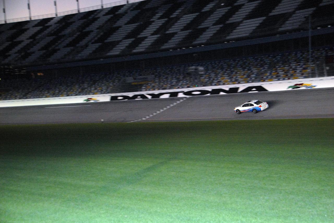 KENNEDY SPACE CENTER, FLA. -- Astronaut Andrew Feustel drives an official track vehicle at Daytona International Speedway. Feustel is participating in NASCAR's Preseason Thunder Fan Fest at the speedway and will ride around the track, taking "hot laps" in the car. Feustel's appearance celebrates NASA's 50th anniversary and the speedway's 50th running of the Daytona 500 in February. Besides the driving experience, Feuster will meet with fans and the media. The NASA/NASCAR association spans decades. Technology developed for the space program has helped NASCAR drivers increase their performance and stay safe over the years. They wear cooling suits similar to what astronauts wear during a spacewalk. Foam that NASA developed for aircraft seats protects racecar drivers' necks in crashes. In addition to participating in the fan festival, NASA will fly three Daytona 500 flags aboard an upcoming space shuttle flight. Speedway officials plan to wave one of the flags to begin the 2008 installment of the Daytona 500, while another will be presented to the winning driver. NASA will keep the third. Feustel will fly on the space shuttle mission STS-125 to the Hubble Space Telescope. The mission will extend and improve the observatory's capabilities through 2013. Launch is targeted for August 2008. Photo credit: NASA/George Shelton