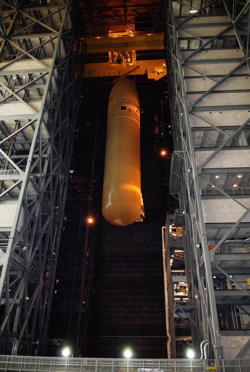KENNEDY SPACE CENTER, FLA. -- In the Vehicle Assembly Building at NASA's Kennedy Space Center, the suspended external tank is lowered into high bay 1 toward the mobile launcher platform.  The tank will be mated with the solid rocket boosters, or SRBs, already installed on the platform.  Work to remove and replace the feed-through connector on the external tank will be done in parallel with integrated ET/SRB testing in preparation for space shuttle Endeavour to join the stack later in January.  The STS-123 mission is targeted for launch on Endeavour in mid-March.  The 25th assembly flight to the International Space Station, Endeavour's payload includes the Japanese Experiment Logistics Module Pressurized Section.  Photo credit: NASA/Kim Shiflett