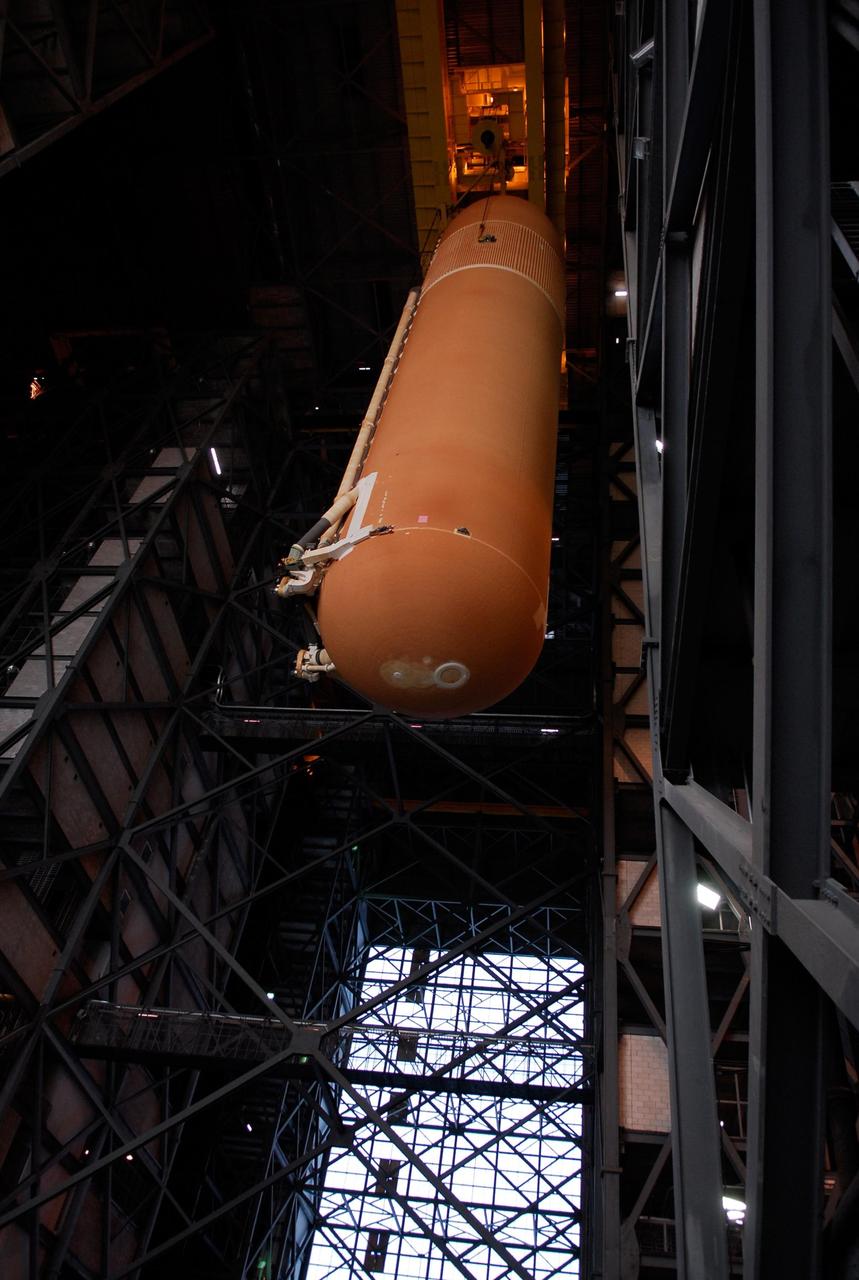 KENNEDY SPACE CENTER, FLA. -- In the Vehicle Assembly Building at NASA's Kennedy Space Center, the suspended external tank is lowered into high bay 1 toward the mobile launcher platform.  The tank will be mated with the solid rocket boosters, or SRBs, already installed on the platform.  Work to remove and replace the feed-through connector on the external tank will be done in parallel with integrated ET/SRB testing in preparation for space shuttle Endeavour to join the stack later in January.  The STS-123 mission is targeted for launch on Endeavour in mid-March.  The 25th assembly flight to the International Space Station, Endeavour's payload includes the Japanese Experiment Logistics Module Pressurized Section.  Photo credit: NASA/Kim Shiflett