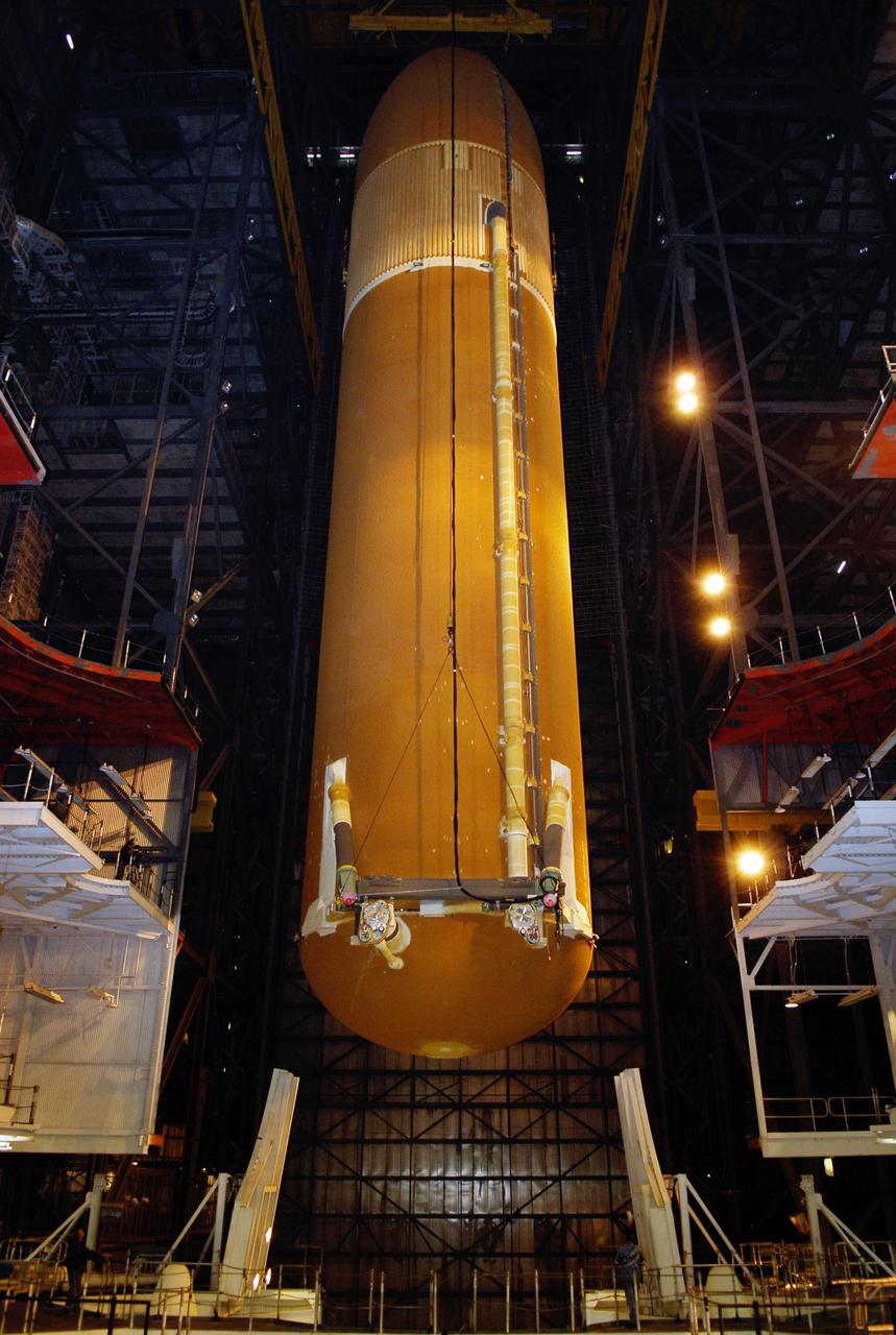 KENNEDY SPACE CENTER, FLA. -- In the Vehicle Assembly Building at NASA's Kennedy Space Center, the suspended external tank is lowered into high bay 1 toward the mobile launcher platform.  The tank will be mated with the solid rocket boosters, or SRBs, already installed on the platform.  Work to remove and replace the feed-through connector on the external tank will be done in parallel with integrated ET/SRB testing in preparation for space shuttle Endeavour to join the stack later in January.  The STS-123 mission is targeted for launch on Endeavour in mid-March.  The 25th assembly flight to the International Space Station, Endeavour's payload includes the Japanese Experiment Logistics Module Pressurized Section.  Photo credit: NASA/Kim Shiflett