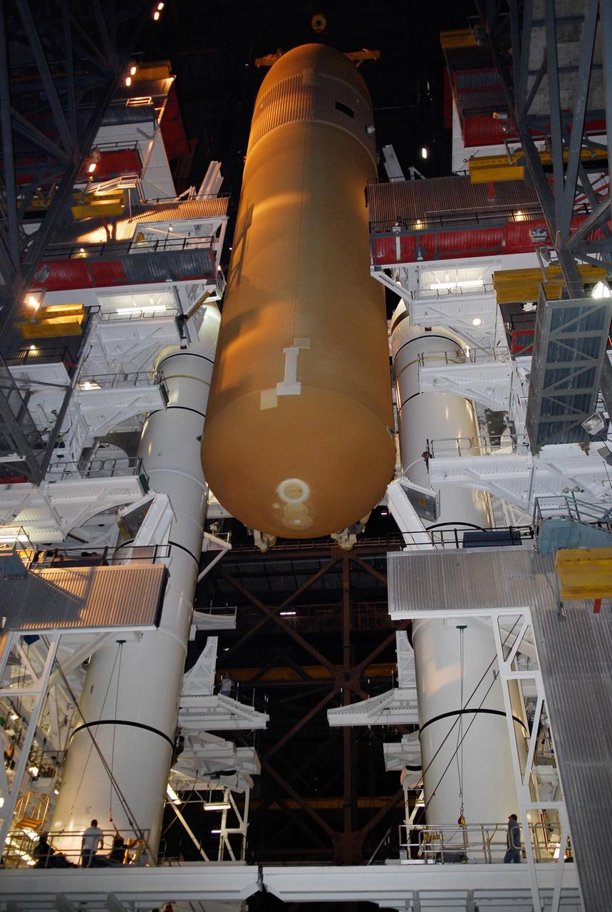 KENNEDY SPACE CENTER, FLA. --  In high bay 1 of the Vehicle Assembly Building at NASA's Kennedy Space Center, the suspended external tank is lowered between the solid rocket boosters, or SRBs, installed on the mobile launcher platform.  The tank will be mated with the boosters for launch.   Work to remove and replace the feed-through connector on the external tank will be done in parallel with integrated ET/SRB testing in preparation for space shuttle Endeavour to join the stack later in January.  The STS-123 mission is targeted for launch on Endeavour in mid-March.  The 25th assembly flight to the International Space Station, Endeavour's payload includes the Japanese Experiment Logistics Module Pressurized Section.  Photo credit: NASA/Kim Shiflett