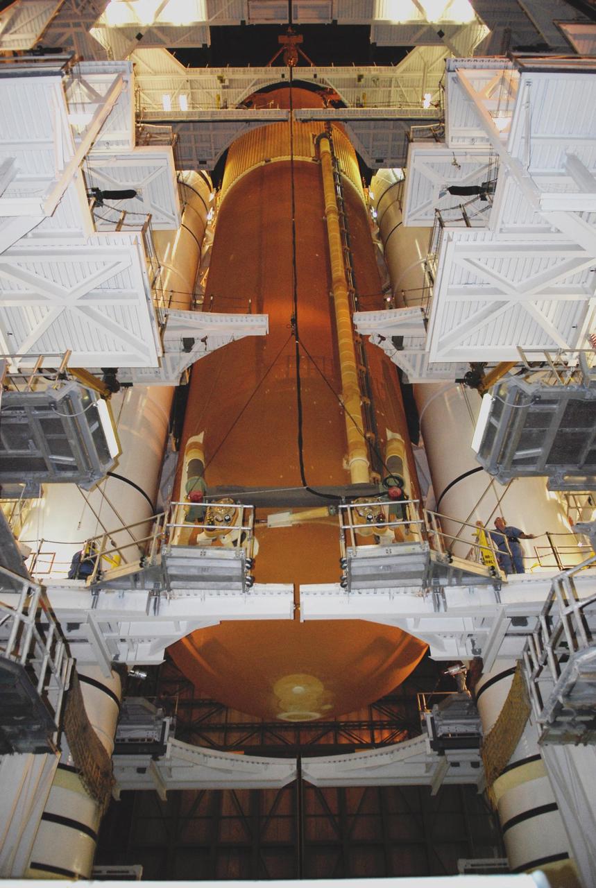 KENNEDY SPACE CENTER, FLA. --  In high bay 1 of the Vehicle Assembly Building at NASA's Kennedy Space Center, the suspended external tank is lowered between the solid rocket boosters, or SRBs, installed on the mobile launcher platform.  The tank will be mated with the boosters for launch.  Work to remove and replace the feed-through connector on the external tank will be done in parallel with integrated ET/SRB testing in preparation for space shuttle Endeavour to join the stack later in January.  The STS-123 mission is targeted for launch on Endeavour in mid-March.  The 25th assembly flight to the International Space Station, Endeavour's payload includes the Japanese Experiment Logistics Module Pressurized Section.  Photo credit: NASA/Kim Shiflett